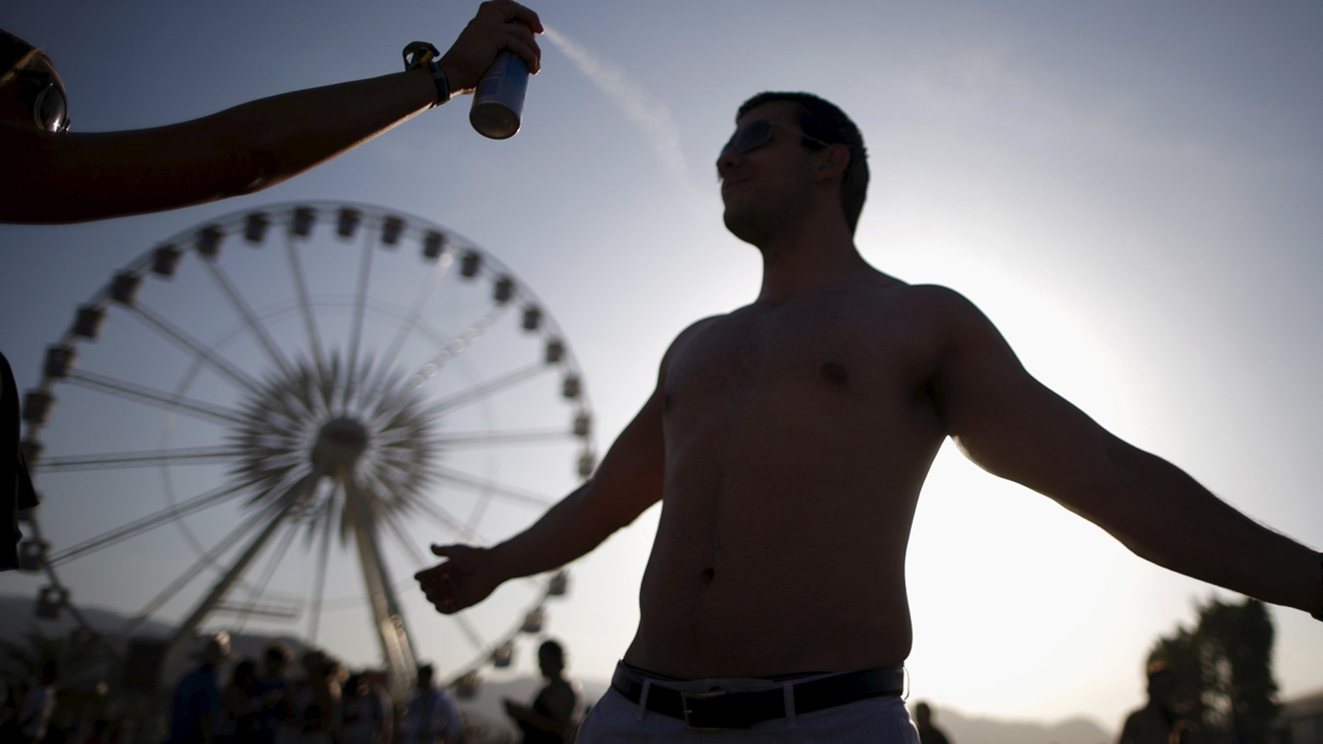 FILE: A man is sprayed with sunscreen in Indioo, Calif.