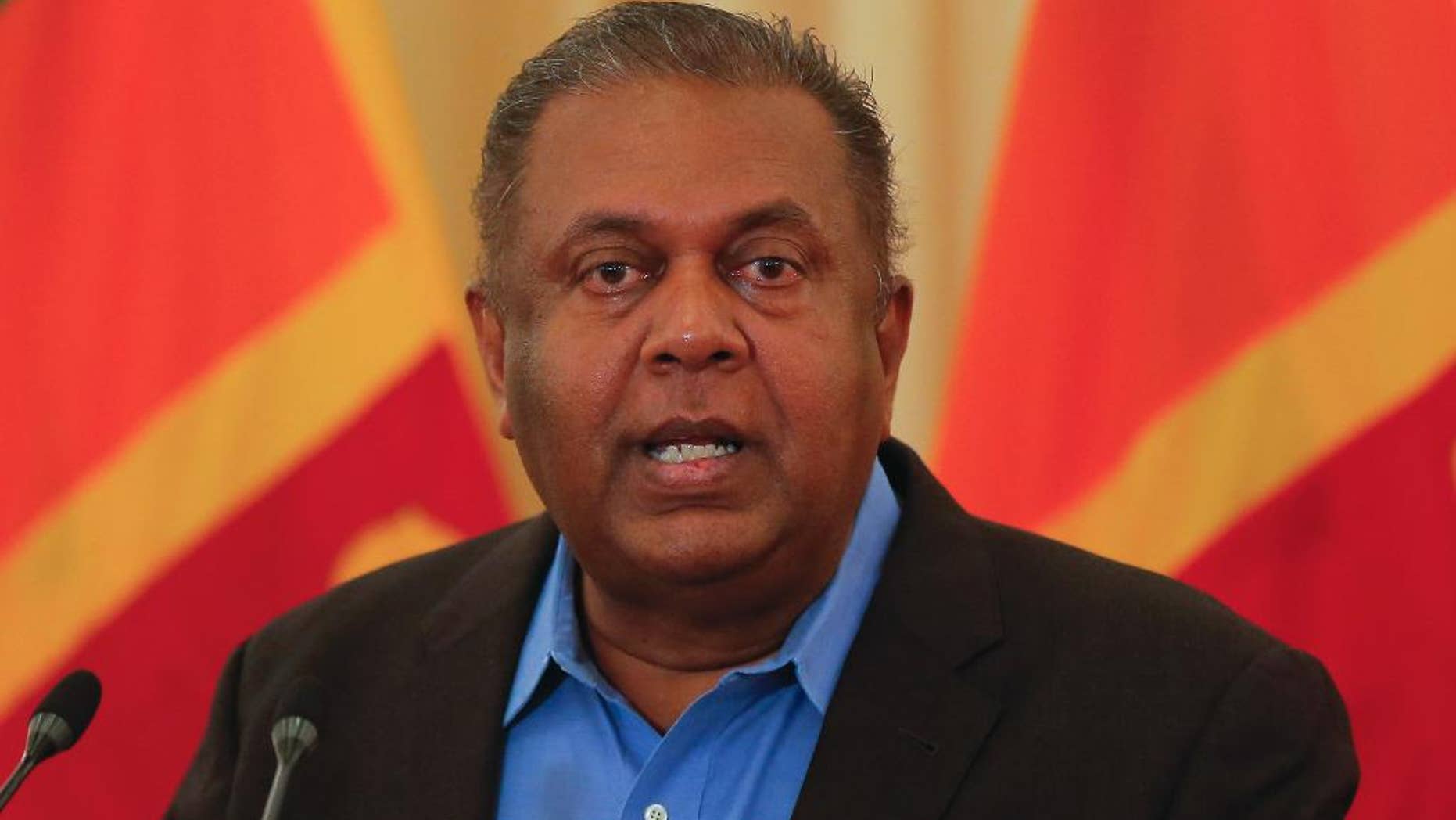 Sri Lankan Foreign Minister Mangala Samaraweera gestures as he addresses the media after returning from a U.N. Human Rights Council meeting in Geneva in Colombo, Sri Lanka, Wednesday, July 6, 2016.Sri Lanka's government plans to set up a special court by next year to hear allegations of abuses during the country's decades-long civil war, the foreign minister said Wednesday. (AP Photo/Eranga Jayawardena)