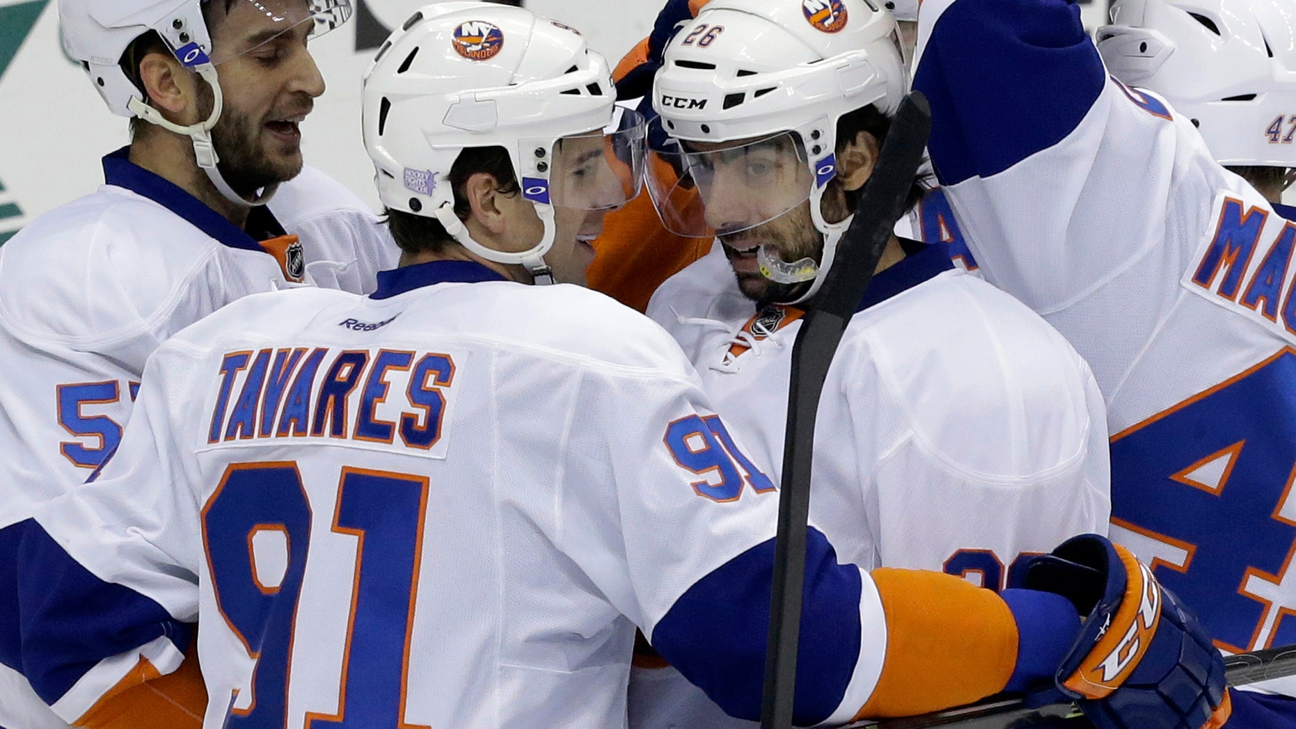 New York Islanders' Matt Moulson (26) celebrates his first-period goal with John Tavares (91) during an NHL hockey game against the Pittsburgh Penguins in Pittsburgh, Friday, Oct. 25, 2013. (AP Photo/Gene J. Puskar)