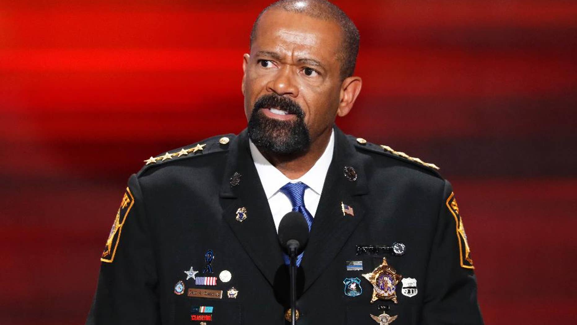FILE- In this July 18, 2016, file photo, David Clarke, Sheriff of Milwaukee County, Wis., speaks during the opening day of the Republican National Convention in Cleveland. A jury on Monday, May 1, 2017, recommended criminal charges against seven Milwaukee County jail staffers in the dehydration death of an inmate who went without water for seven days. The jail is overseen by Clarke, but the inquest did not target him. (AP Photo/J. Scott Applewhite, File)