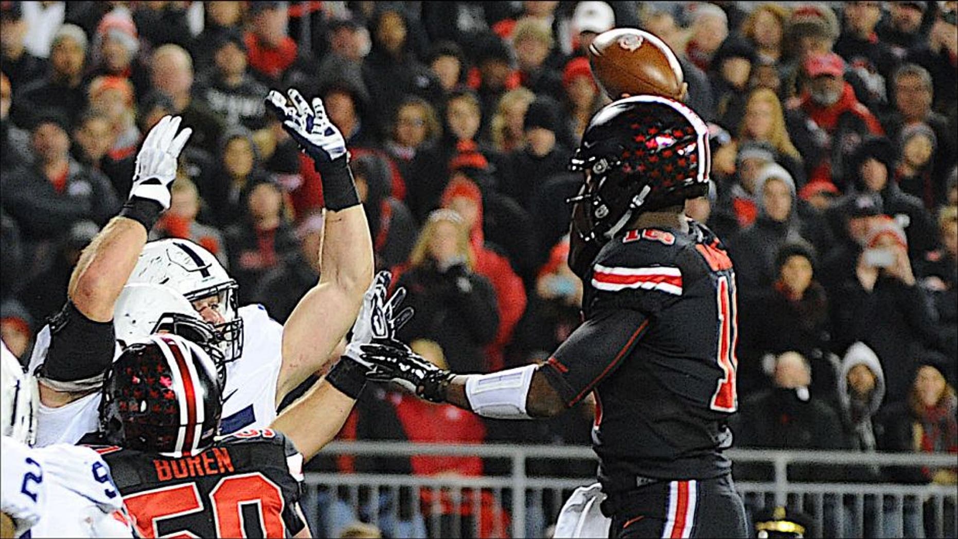 Oct 17, 2015; Columbus, OH, USA; Ohio State Buckeyes quarterback J.T. Barrett (16) throws a touchdown pass in the fourth quarter against the Penn State Nittany Lions at Ohio Stadium. Mandatory Credit: James Lang-USA TODAY Sports