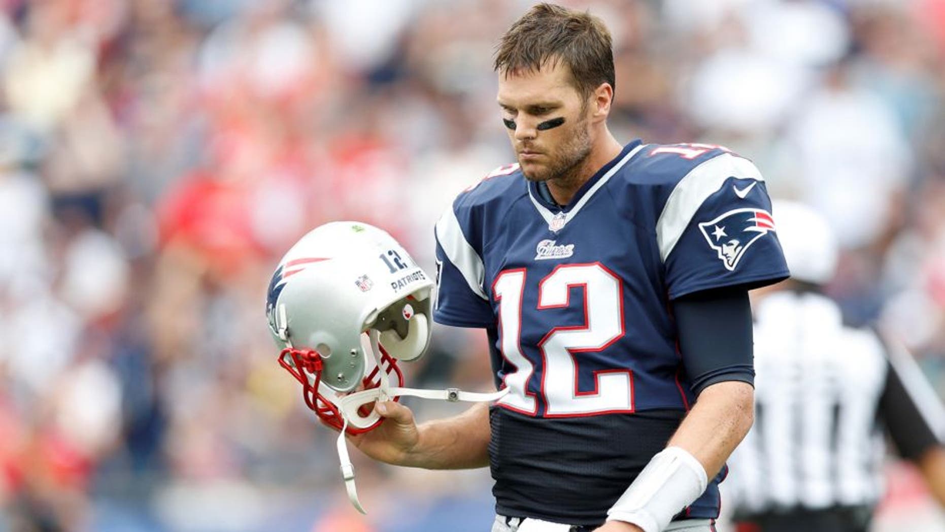 Sep 21, 2014; Foxborough, MA, USA; New England Patriots quarterback Tom Brady (12) reacts to a failed pass attempt during the fourth quarter against Oakland Raiders at Gillette Stadium. The New England Patriots won 16-9. Mandatory Credit: Greg M. Cooper-USA TODAY Sports