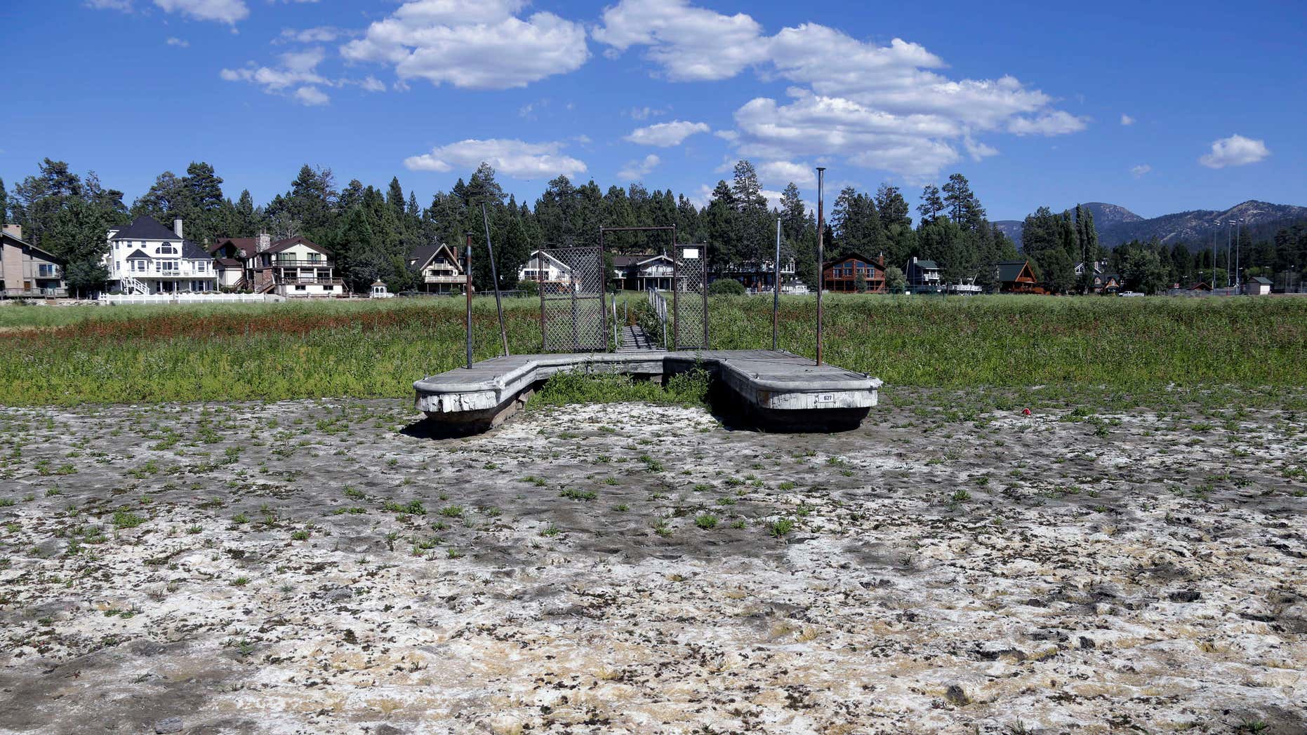 FILE - This Aug. 24, 2015, file photo, shows a boat dock by the lake bed where water has dried due to the drought at Big Bear Lake, Calif.