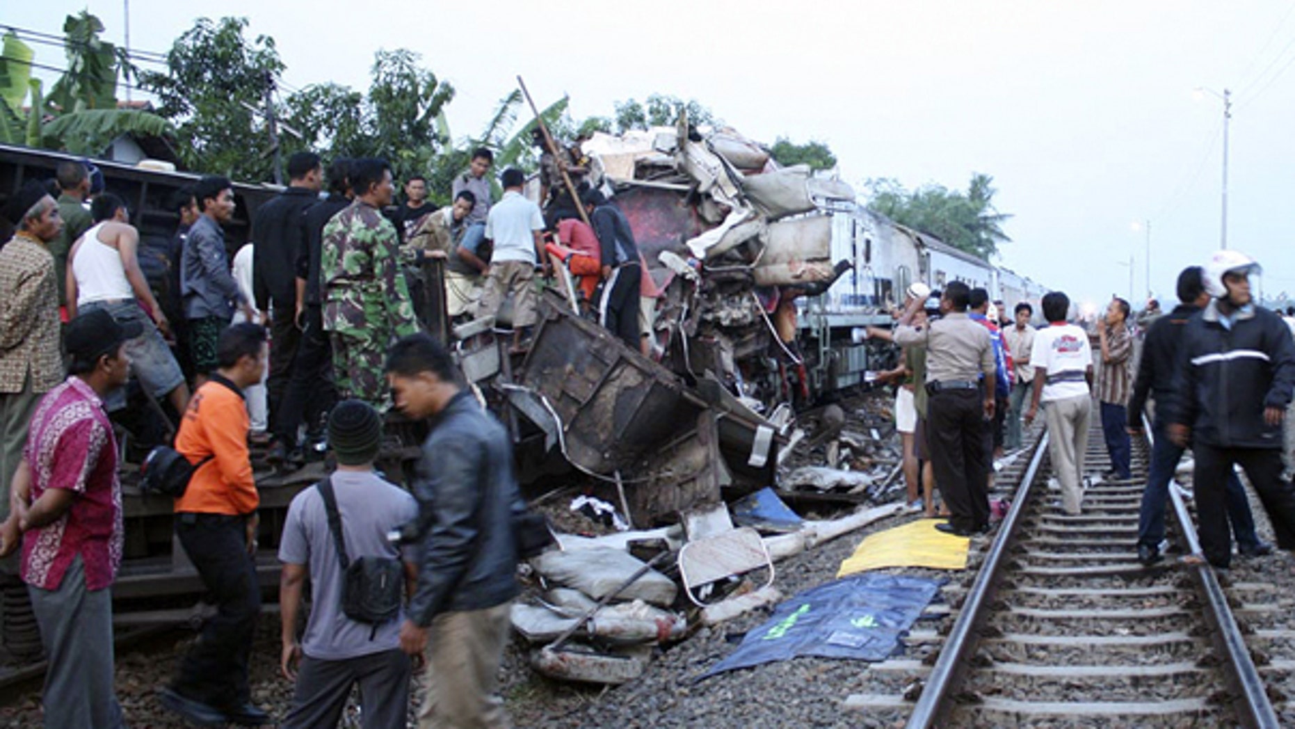 Oct. 2: Rescuers search for victims of a train crash near a station in Petarukan, Indonesia. The early morning train crash killed at least 36 and injured dozens, many of critically, officials and witnesses said.