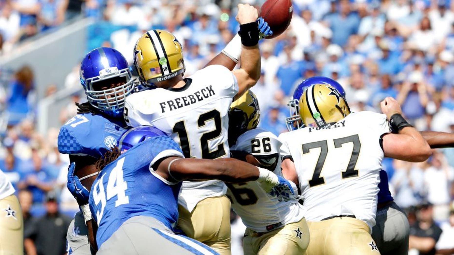 Sep 27, 2014; Lexington, KY, USA; Kentucky Wildcats defensive tackle Cory Johnson (67) deflects the pass of Vanderbilt Commodores quarterback Wade Freebeck (12) in the second half at Commonwealth Stadium. Kentucky defeated Vanderbilt 17-7. Mandatory Credit: Mark Zerof-USA TODAY Sports