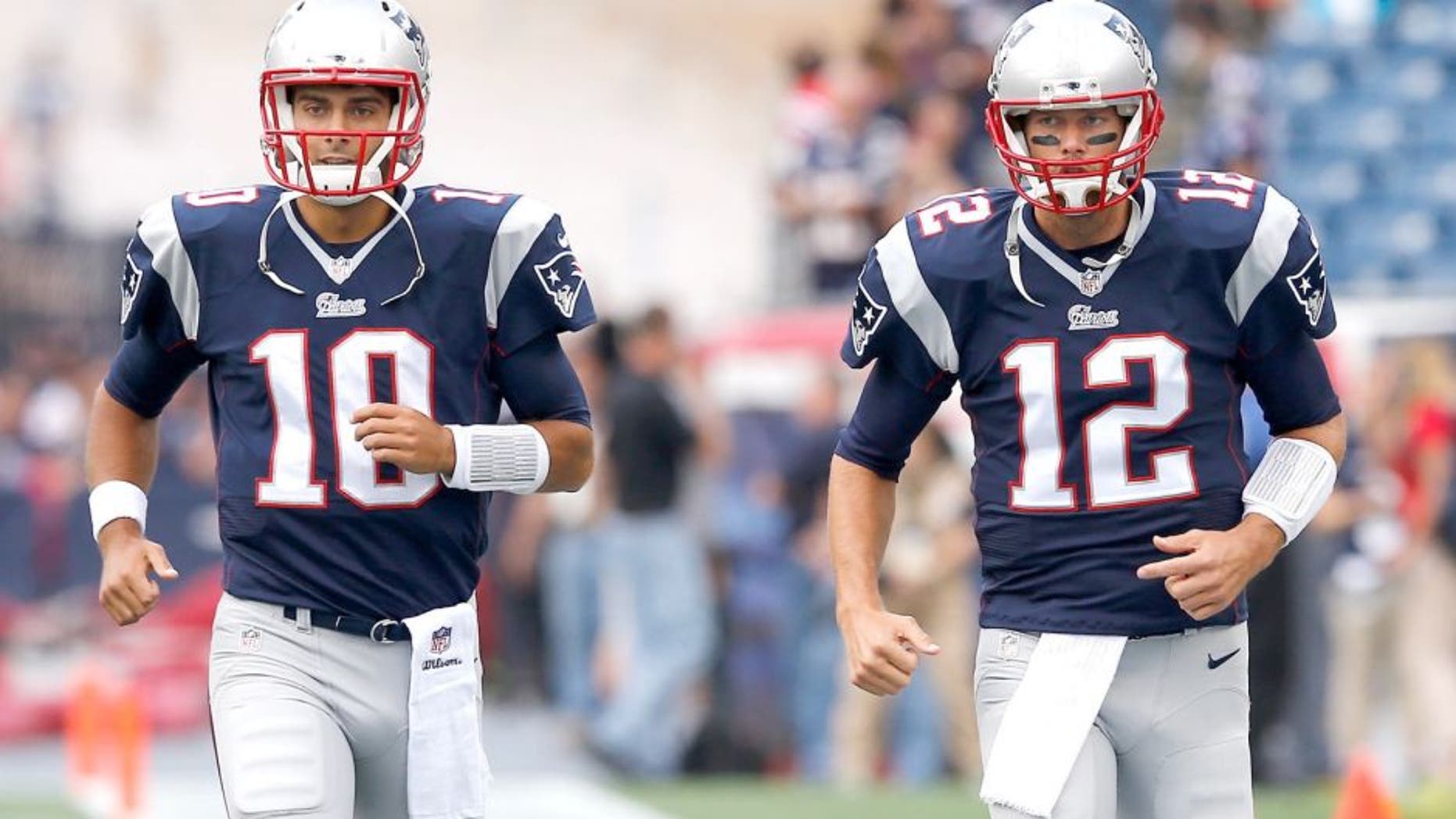 FOXBORO, MA - SEPTEMBER 21: Jimmy Garoppolo #10 and Tom Brady #12 of the New England Patriots warm up during pre-game before playing the Oakland Raiders at Gillette Stadium on September 21, 2014 in Foxboro, Massachusetts. (Photo by Jim Rogash/Getty Images)