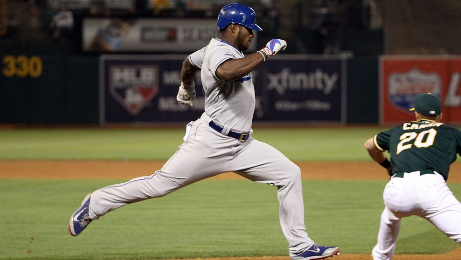 OAKLAND, CA - AUGUST 18: Yasiel Puig #66 of the Los Angeles Dodgers runs to first base against the Oakland Athletics at O.co Coliseum on August 18, 2015 in Oakland, California. (Photo by Ezra Shaw/Getty Images)