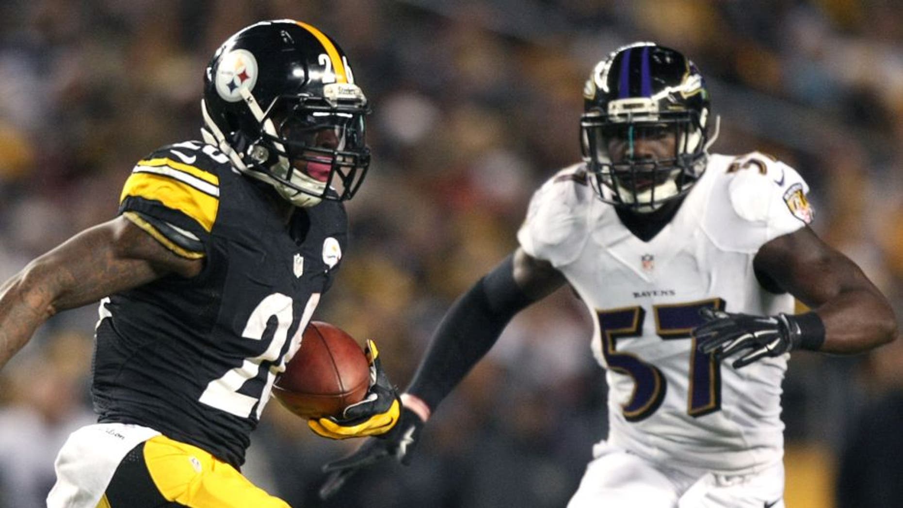 Nov 2, 2014; Pittsburgh, PA, USA; Pittsburgh Steelers running back Le'Veon Bell (26) runs the ball against Baltimore Ravens linebacker C.J. Mosley (57) during the first half of the game at Heinz Field. Mandatory Credit: Jason Bridge-USA TODAY Sports