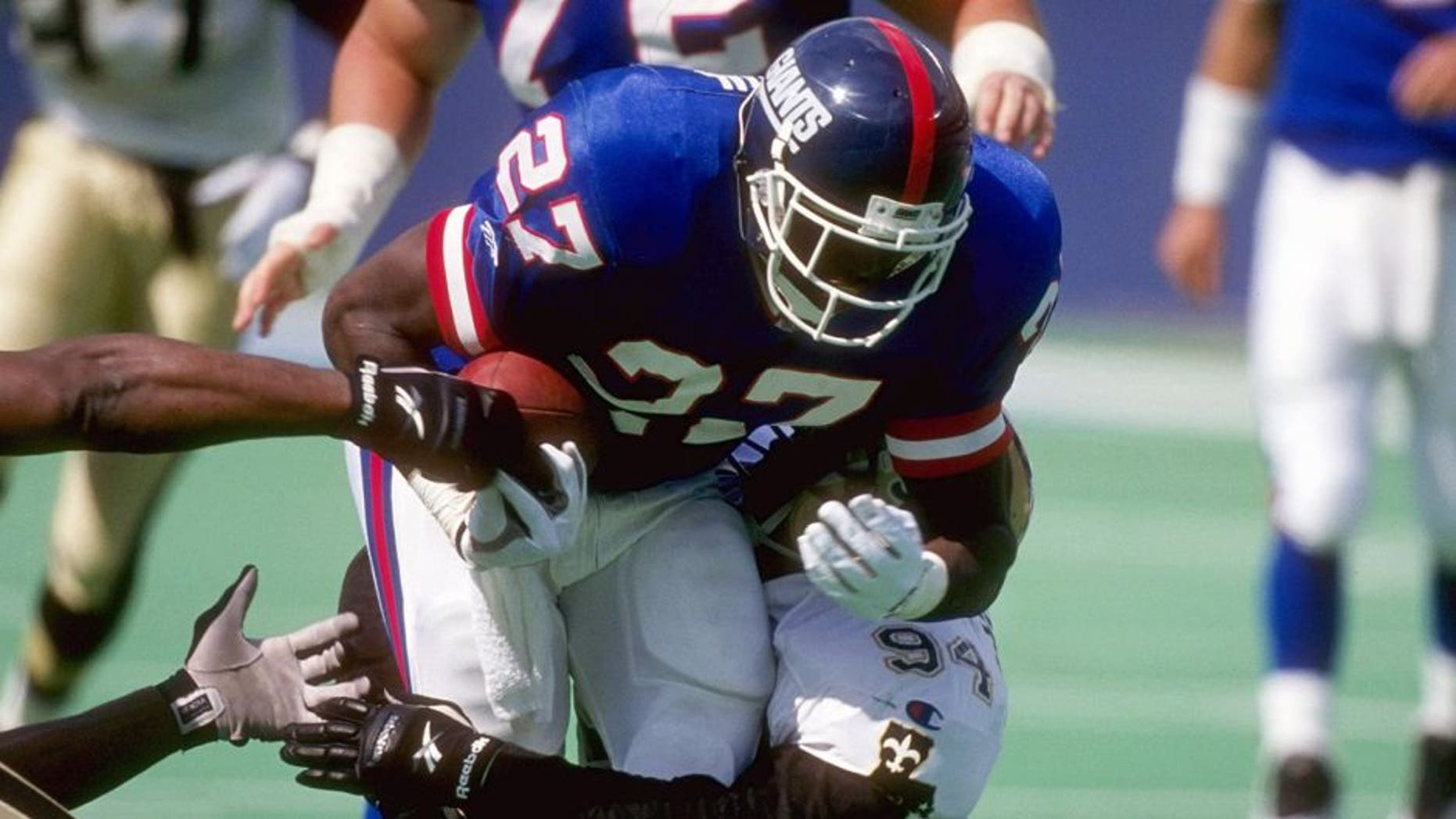 24 Sep 1995: Running back Rodney Hampton #27 of the New York Giants attempts to run through the tackle of defensive lineman Joe Johnson #94 of the New Orleans Saints during a game held at the Meadowlands in East Rutherford, New Jersey. The Giants won th