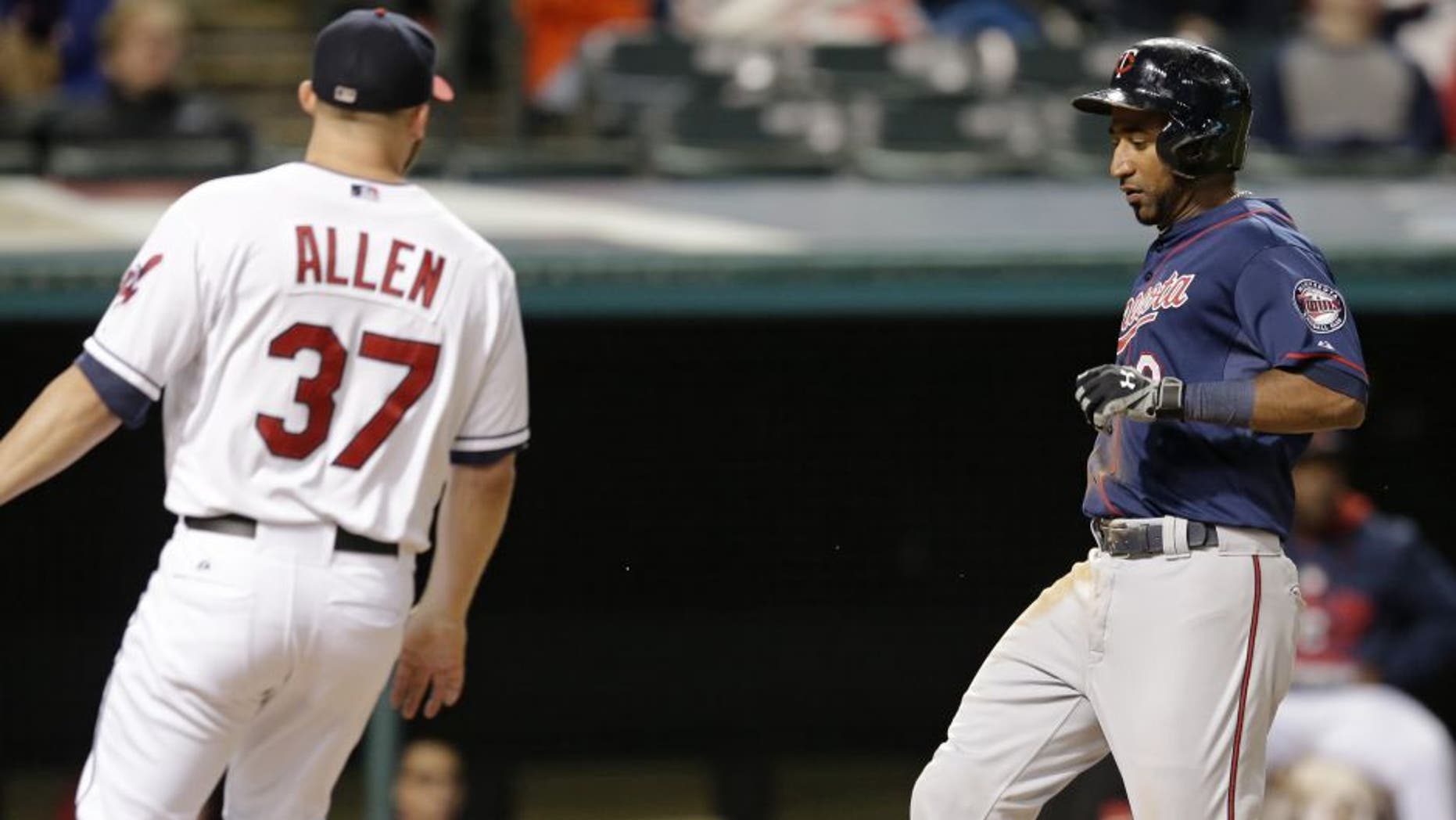 Minnesota Twins' Eduardo Nunez scores on a wild pitch by Cleveland Indians relief pitcher Cody Allen in the ninth inning