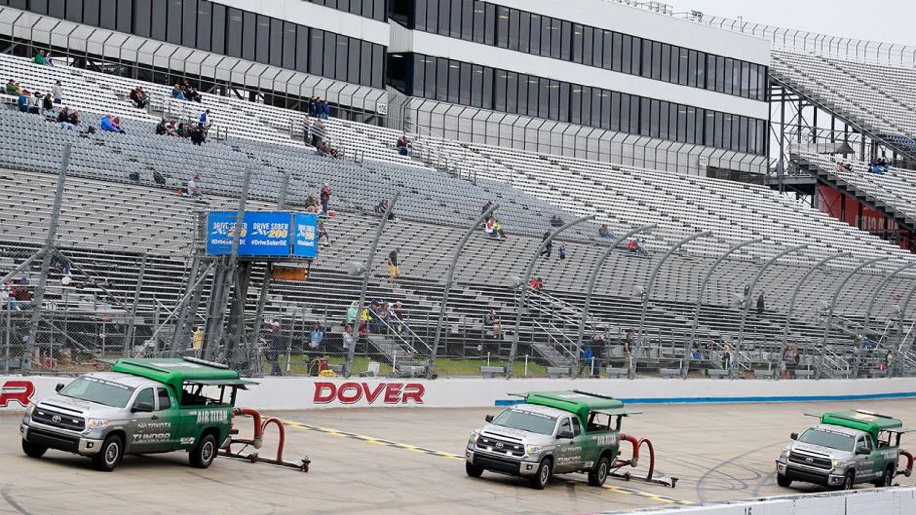 DOVER, DE - OCTOBER 01: Air Titan 2.0 trucks work to dry the track after qualifying for the NASCAR XFINITY Series Drive Sober 200 at Dover International Speedway on October 1, 2016 in Dover, Delaware. (Photo by Matt Sullivan/Getty Images)