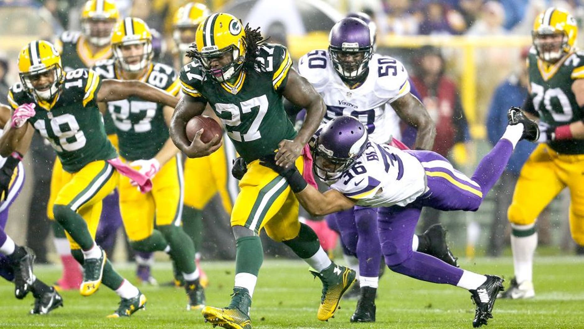 GREEN BAY, WI - OCTOBER 2: Eddie Lacy #27 of the Green Bay Packers carries the football against Robert Blanton #36 of the Minnesota Vikings in the first half of the NFL game on October 02, 2014 at Lambeau Field in Green Bay, Wisconsin. (Photo by John Konstantaras/Getty Images)