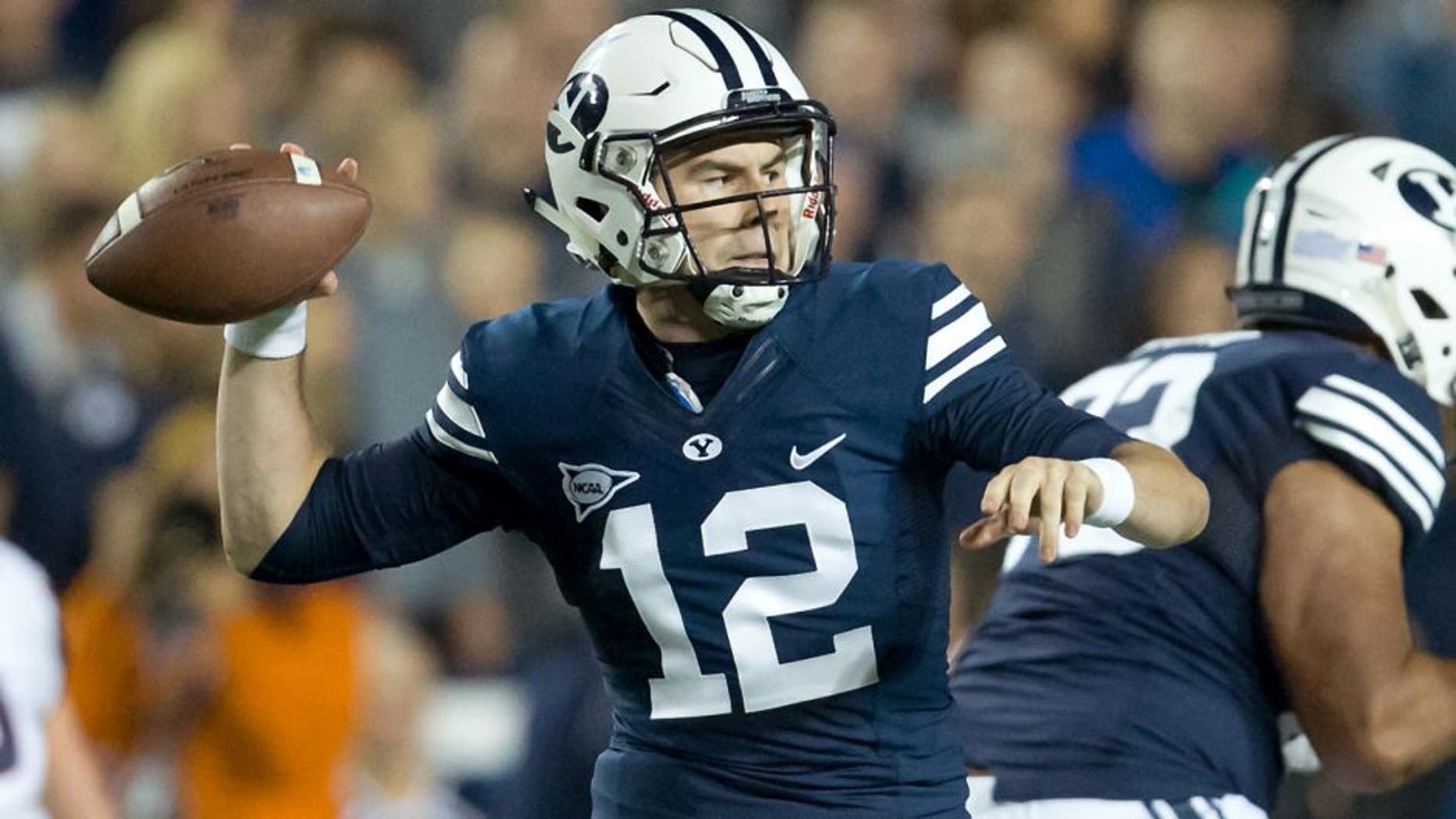 Oct 2, 2015; Provo, UT, USA; Brigham Young Cougars quarterback Tanner Mangum (12) passes the ball during the first quarter against the Connecticut Huskies at Lavell Edwards Stadium. Mandatory Credit: Russ Isabella-USA TODAY Sports
