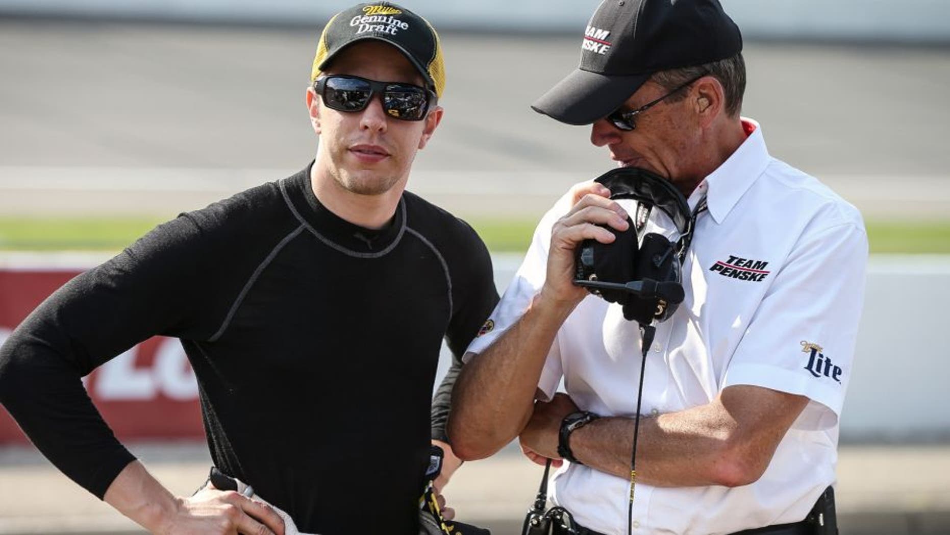 Brad Keselowski, driver of the #2 Miller Lite Ford, stands on the grid during practice for the NASCAR Sprint Cup Series Pure Michigan 400 at Michigan International Speedway on August 14, 2015 in Brooklyn, Michigan.