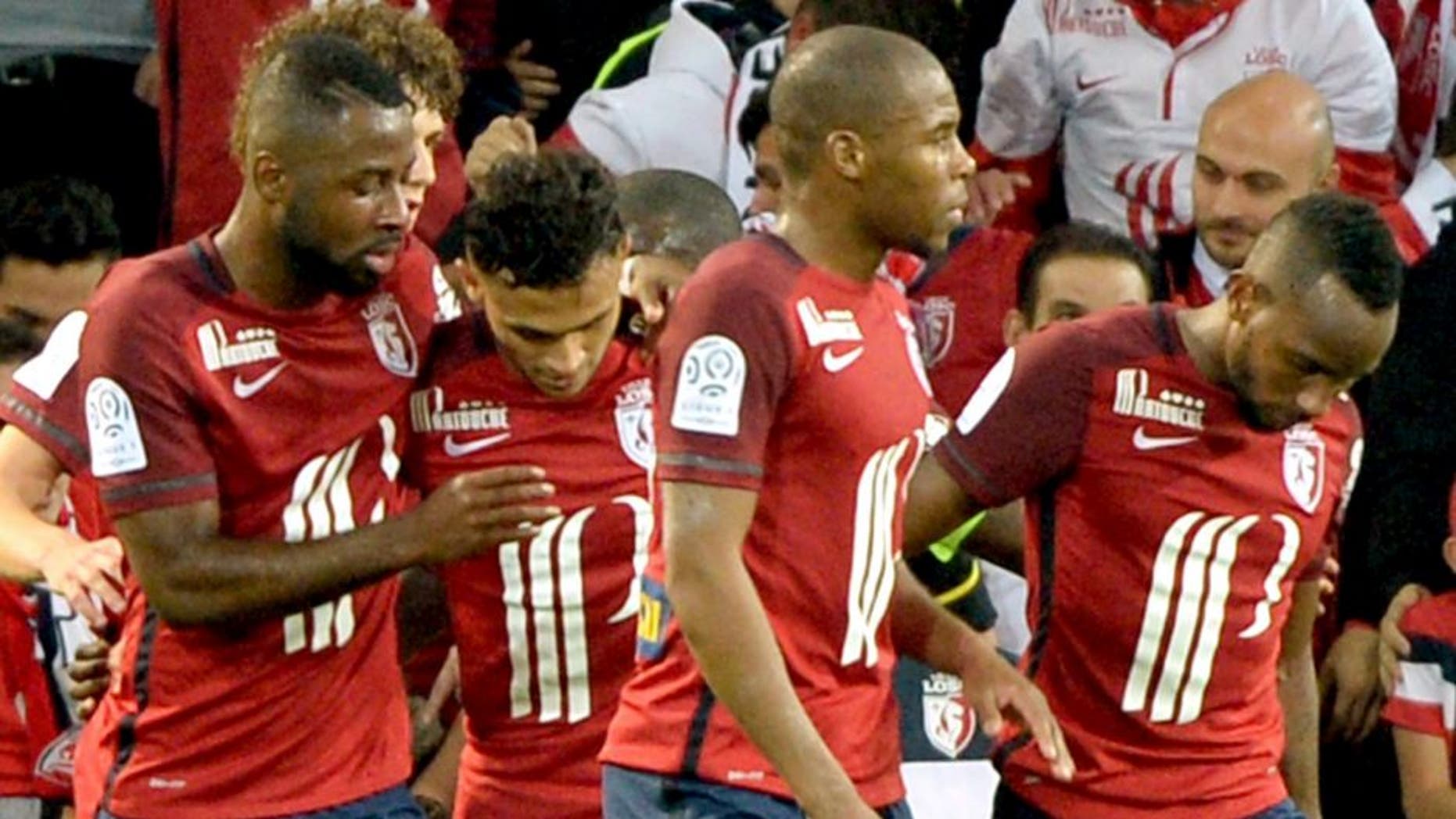 ALTERNATIVE CROP Lille's French midfielder Sofiane Boufal (C) celebrates with teammates after scoring a goal during the French L1 football match between Lille and Montpellier on October 2, 2015 at the Pierre Mauroy stadium in Villeneuve d'Ascq, northern France. AFP PHOTO / DENIS CHARLET (Photo credit should read DENIS CHARLET/AFP/Getty Images)