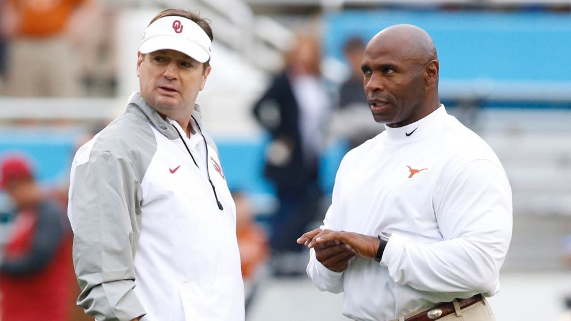 Oct 11, 2014; Dallas, TX, USA; Oklahoma Sooners head coach Bob Stoops (L) talks with Texas Longhorns head coach Charlie Strong before the game at the Cotton Bowl. Mandatory Credit: Tim Heitman-USA TODAY Sports