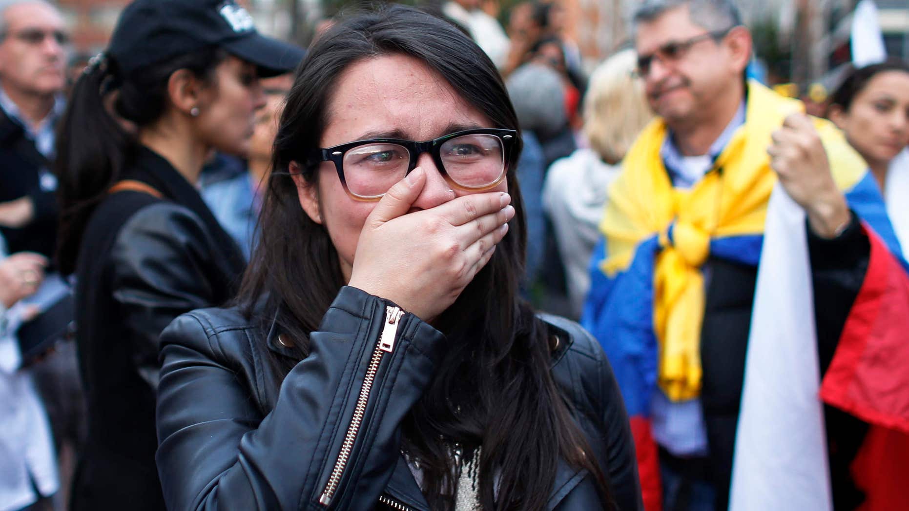 Oct. 2, 2016: A supporter of the peace accord signed between the Colombian government and rebels of the Revolutionary Armed Forces of Colombia, FARC, cries as she follows on a giant screen the results of a referendum to decide whether or not to support the deal in Bogota, Colombia,.