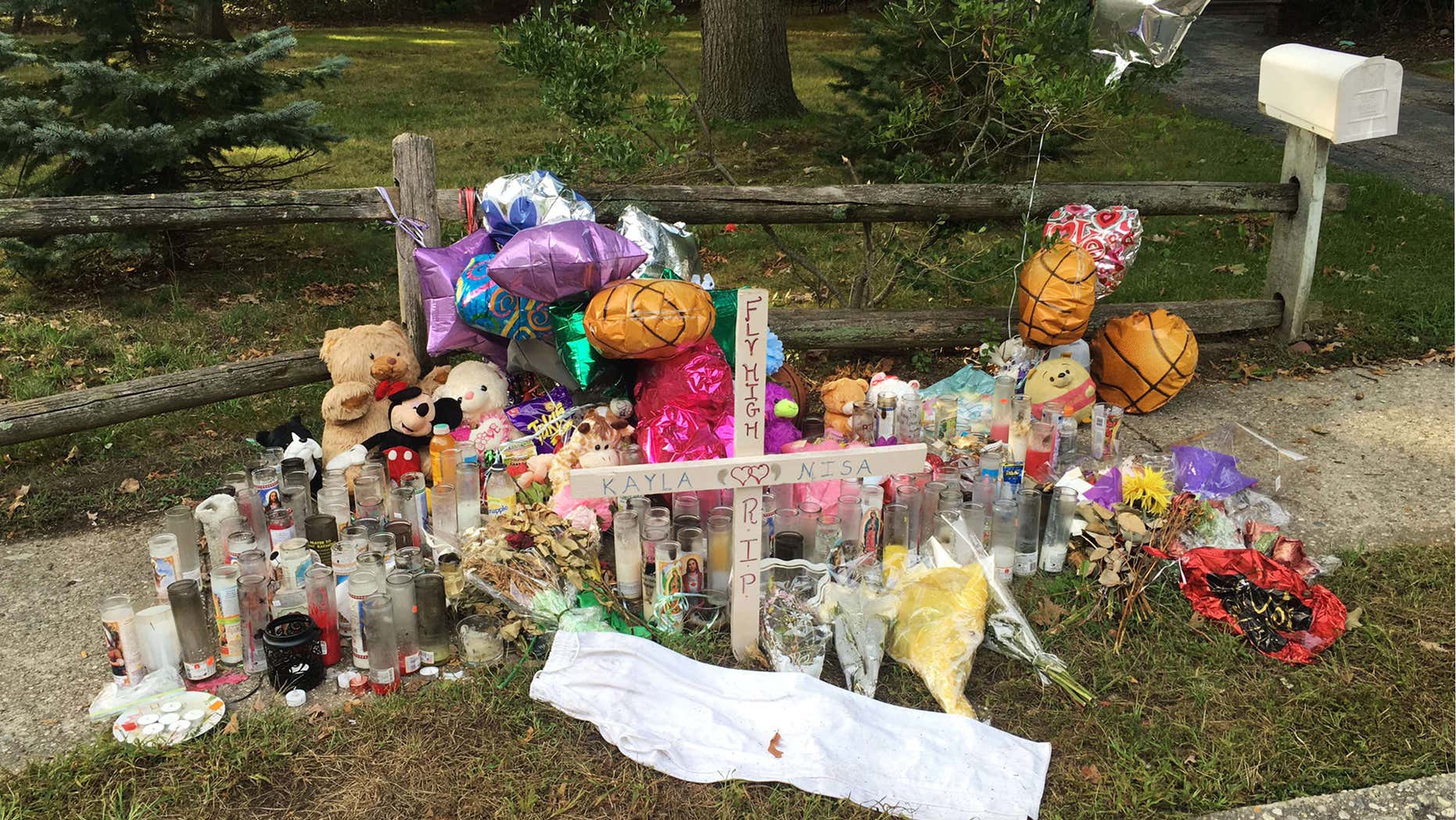 In this Sept. 27, 2016 photo, a memorial for Nisa Mickens and Kayla Cueva is located near the locations where their bodies were found in Brentwood, N.Y.