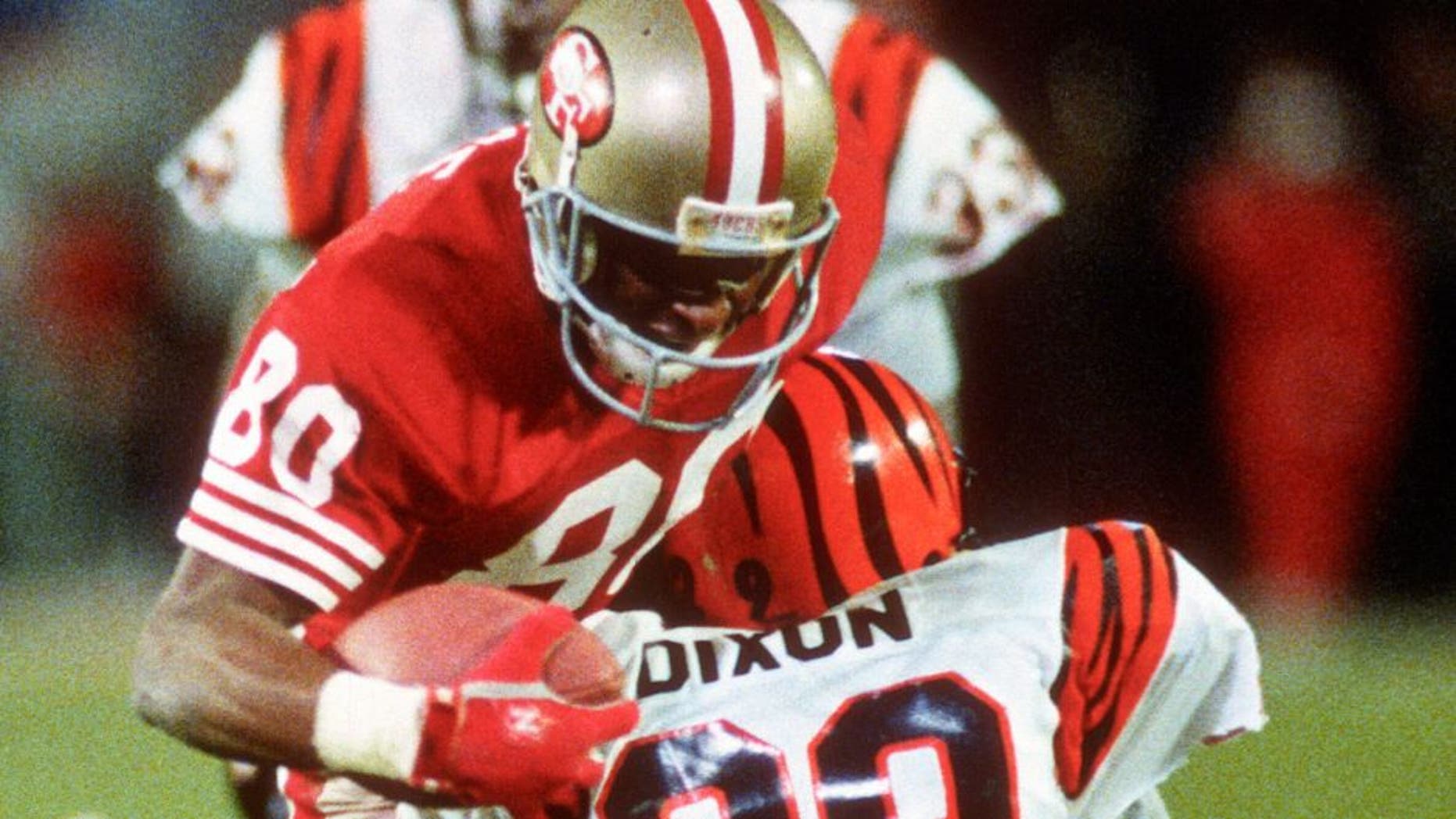 MIAMI, FL- JANUARY 22: Jerry Rice #80 of the San Francisco 49ers gets tackled by Rickey Dixon #29 of the Cincinnati Bengals during Super Bowl XXIII on January 22, 1989 at Joe Robbie Stadium in Miami, Florida. The 49ers won the Super Bowl 20-16. (Photo by Focus on Sport/Getty Images) *** Local Caption *** Jerry Rice; Rickey Dixon