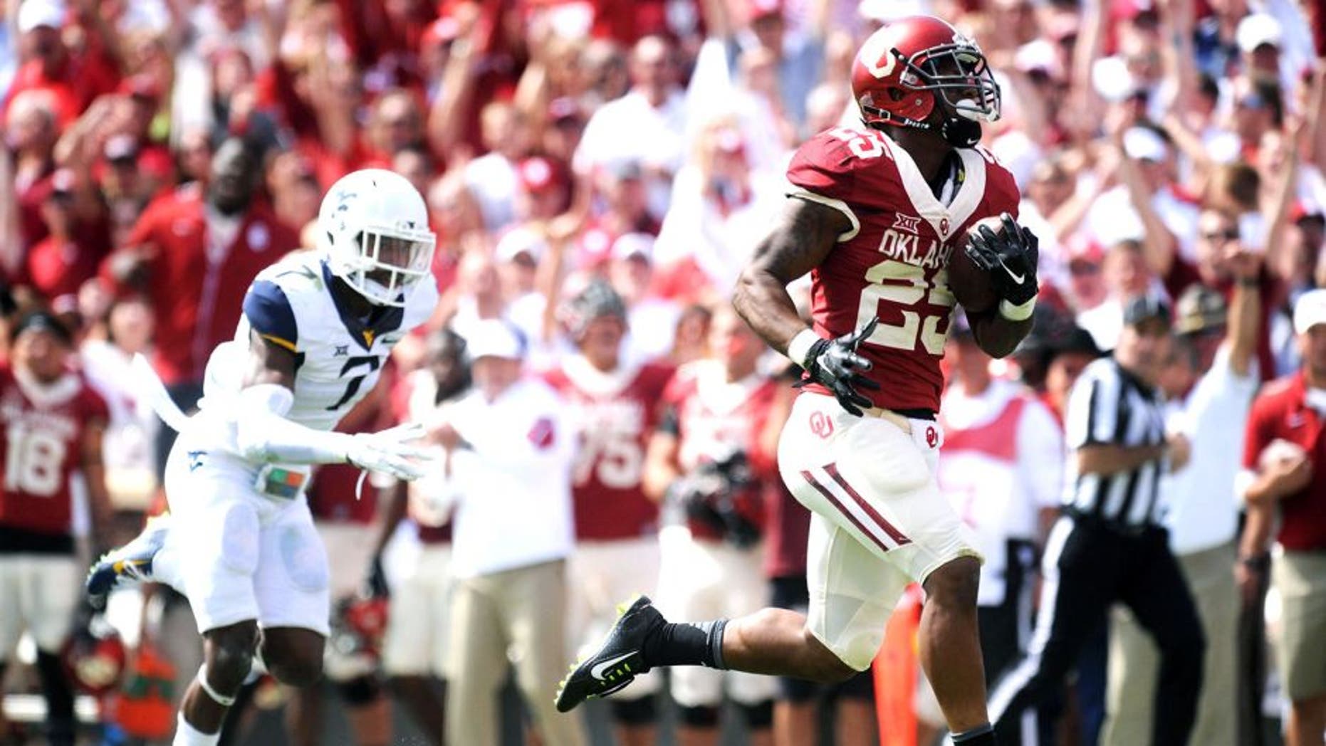 Oct 3, 2015; Norman, OK, USA; Oklahoma Sooners running back Joe Mixon (25) runs for a touchdown against the West Virginia Mountaineers in the second quarter at Gaylord Family - Oklahoma Memorial Stadium. Mandatory Credit: Mark D. Smith-USA TODAY Sports