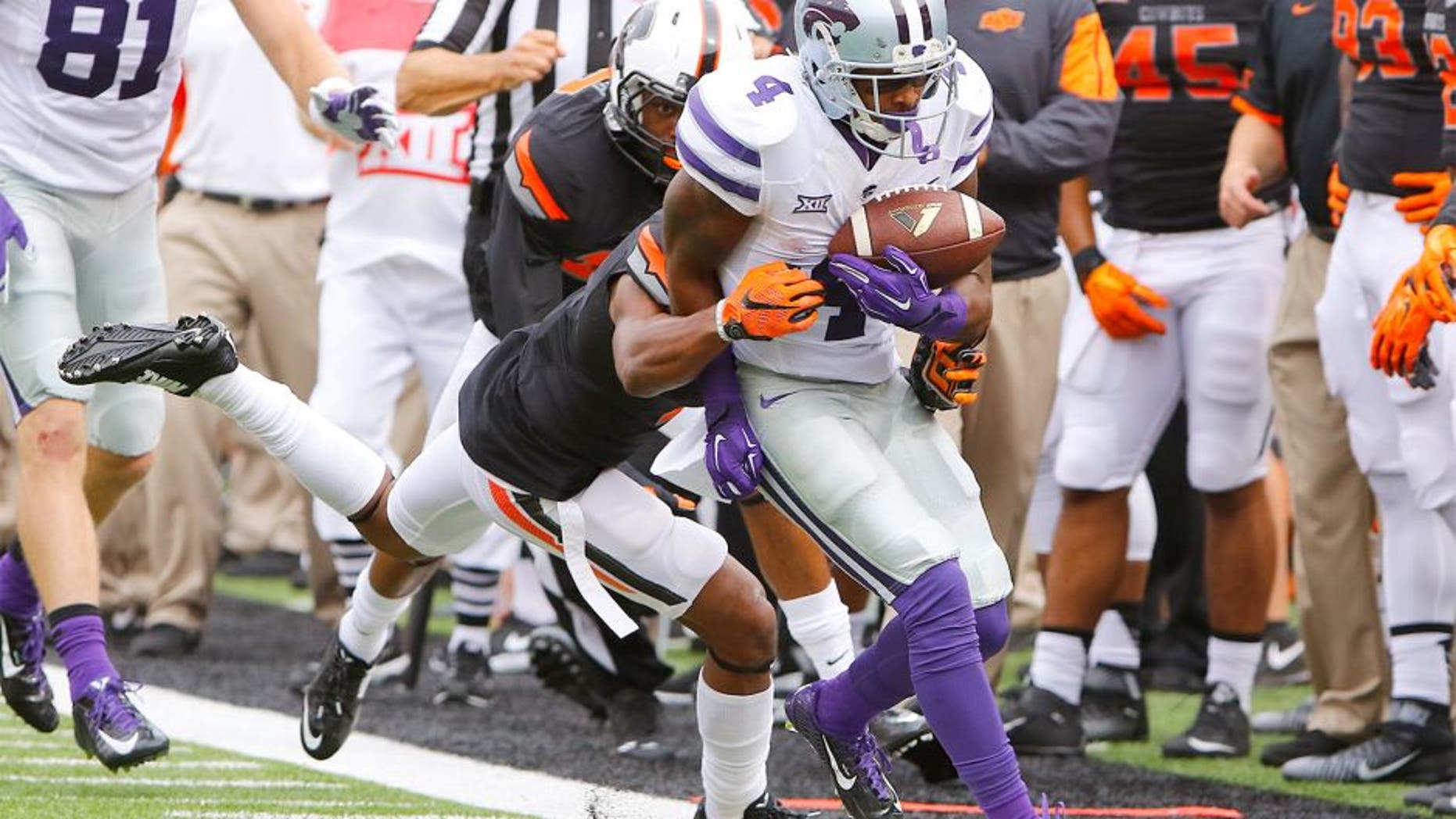 Oct 3, 2015; Stillwater, OK, USA; Kansas State Wildcats wide receiver Dominique Heath (4) is pushed out of bounds against the Oklahoma State Cowboy during the first quarter at Boone Pickens Stadium. Mandatory Credit: Alonzo Adams-USA TODAY Sports