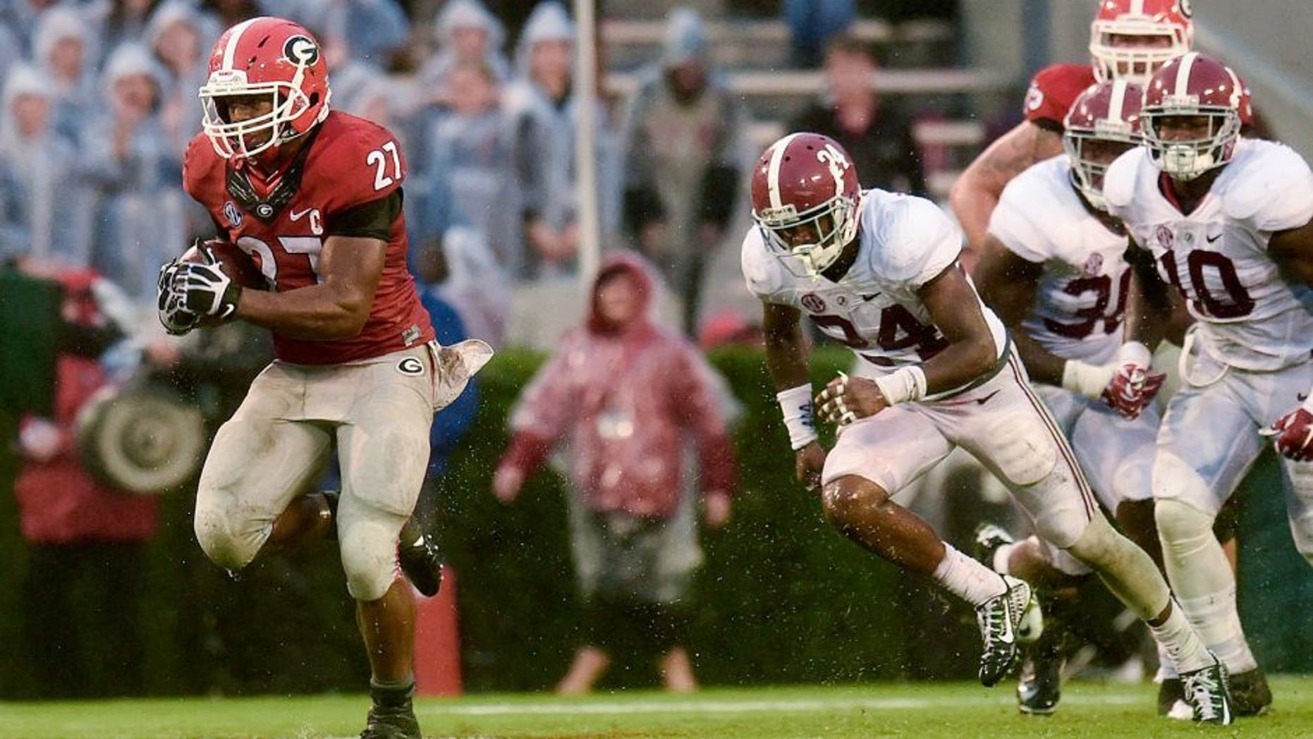 Oct 3, 2015; Athens, GA, USA; Georgia Bulldogs running back Nick Chubb (27) runs the ball past Alabama Crimson Tide defensive back Geno Matias-Smith (24) for a touchdown during the third quarter at Sanford Stadium. Mandatory Credit: Dale Zanine-USA TODAY Sports