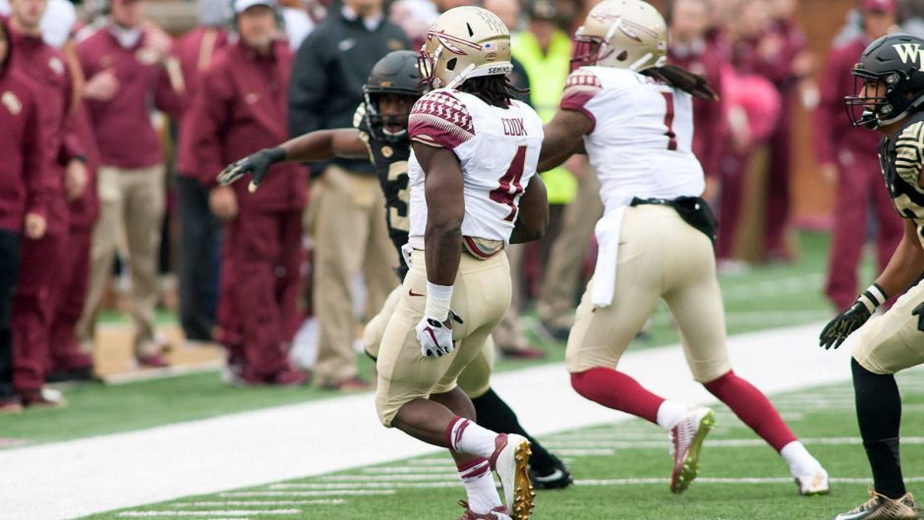 Oct 3, 2015; Winston-Salem, NC, USA; Florida State Seminoles running back Dalvin Cook (4) holds the back of his leg and limps towards the sidelines during a play in the first quarter against the Wake Forest Demon Deacons at BB&T Field. Mandatory Credit: Jeremy Brevard-USA TODAY Sports