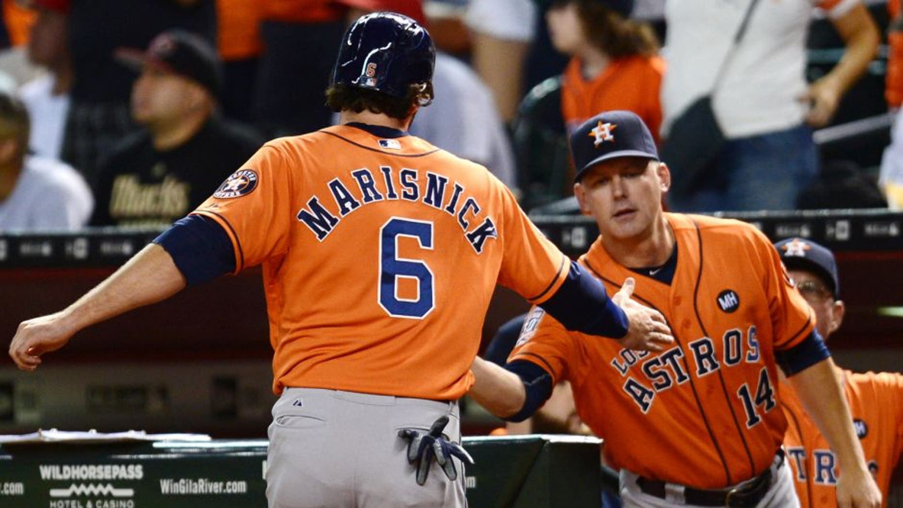 Oct 3, 2015; Phoenix, AZ, USA; Houston Astros center fielder Jake Marisnick (6) slaps hands with Houston Astros manager A.J. Hinch (14) after scoring a run in the seventh inning against the Arizona Diamondbacks at Chase Field. Mandatory Credit: Joe Camporeale-USA TODAY Sports