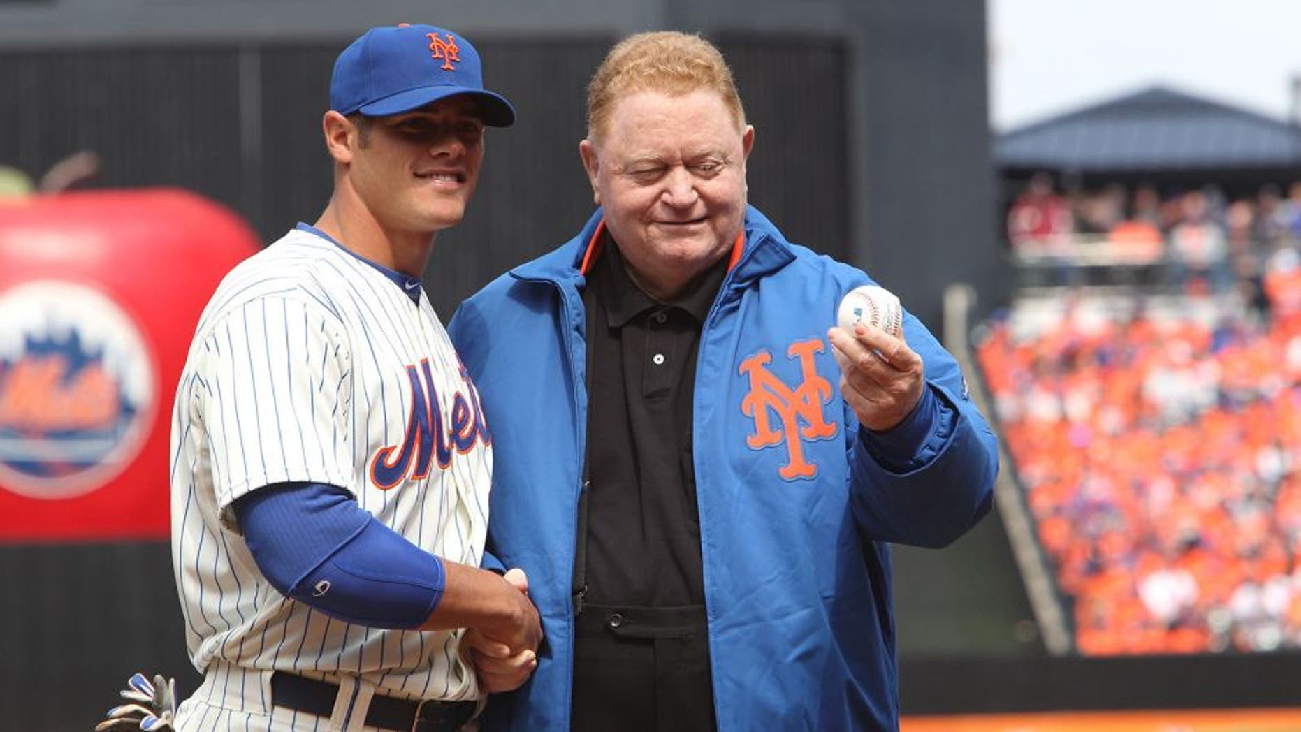 NEW YORK, NY - APRIL 01: Former New York Mets player Rusty Staub throws out the first pitch to Catcher Anthony Recker #20 of the New York Mets before the game against the San Diego Padres on Opening Day at Citi Field on April 1, 2013 in New York City. Mets beat the Padres, 11-2. (Photo by Al Pereira/Getty Images)