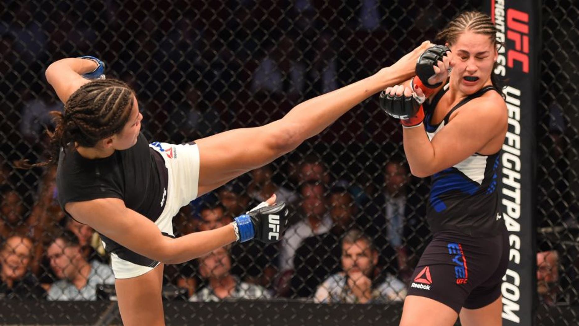 HOUSTON, TX - OCTOBER 03: (L-R) Julianna Pena kicks Jessica Eye in their women's bantamweight bout during the UFC 192 event at the Toyota Center on October 3, 2015 in Houston, Texas. (Photo by Josh Hedges/Zuffa LLC/Zuffa LLC via Getty Images)