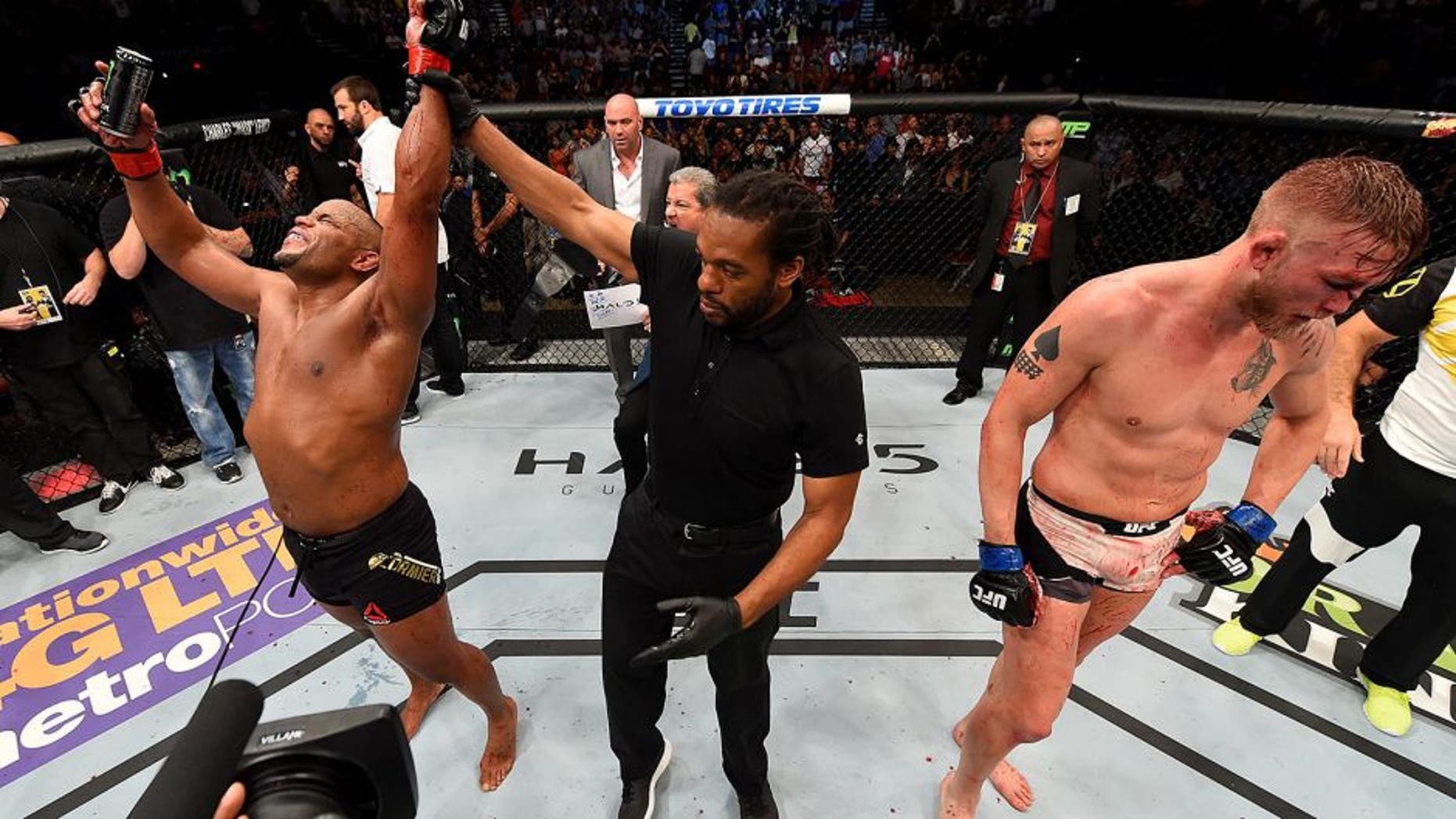 HOUSTON, TX - OCTOBER 03: (L-R) Daniel Cormier celebrates his victory over Alexander Gustafsson in their UFC light heavyweight championship bout during the UFC 192 event at the Toyota Center on October 3, 2015 in Houston, Texas. (Photo by Josh Hedges/Zuffa LLC/Zuffa LLC via Getty Images)