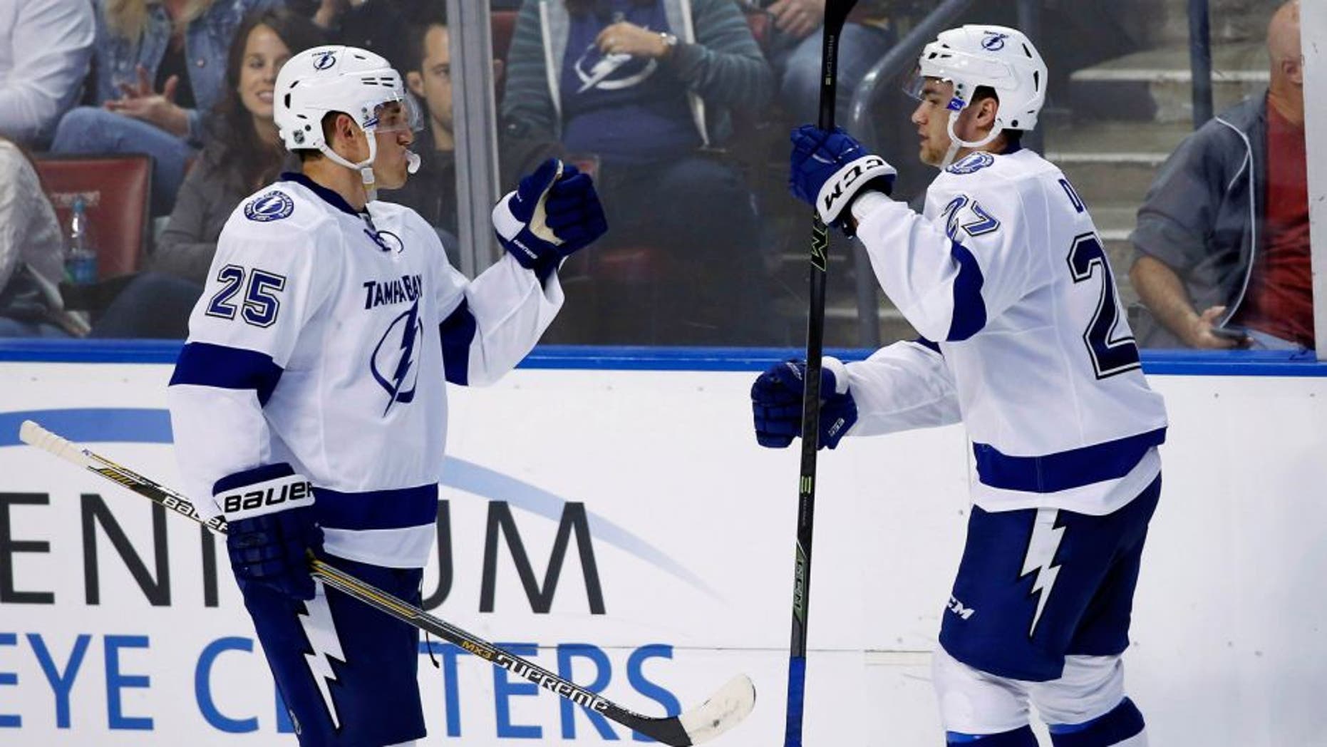 Oct 3, 2015; Sunrise, FL, USA; Tampa Bay Lightning left wing Jonathan Drouin (27) celebrates his game winning goal with defenseman Matt Carle (25) in the third period of a game against the Florida Panthers at BB&T Center. The Lightning won 3-2. Mandatory Credit: Robert Mayer-USA TODAY Sports