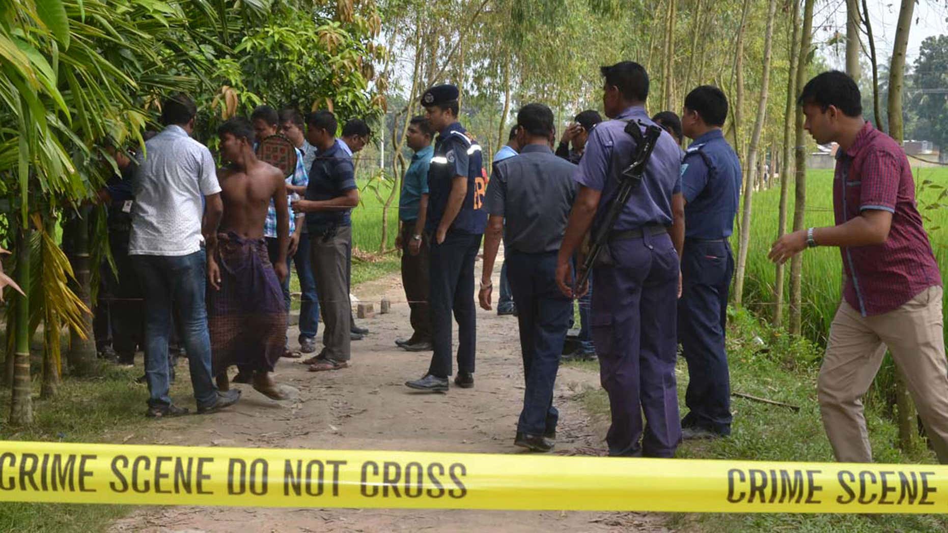 Oct. 3, 2015: Bangladeshi security officers stand by the site where a Japanese Kunio Hoshi was killed at Mahiganj village in Rangpur district, 300 kilometers (185 miles) north of Dhaka, Bangladesh.