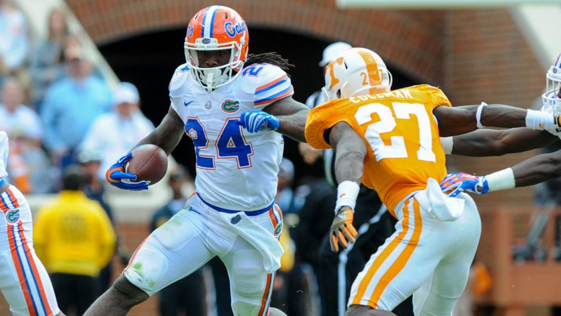 Oct 4, 2014; Knoxville, TN, USA; Florida Gators running back Matt Jones (24) runs the ball against Tennessee Volunteers defensive back Justin Coleman (27) during the second quarter at Neyland Stadium. Mandatory Credit: Randy Sartin-USA TODAY Sports