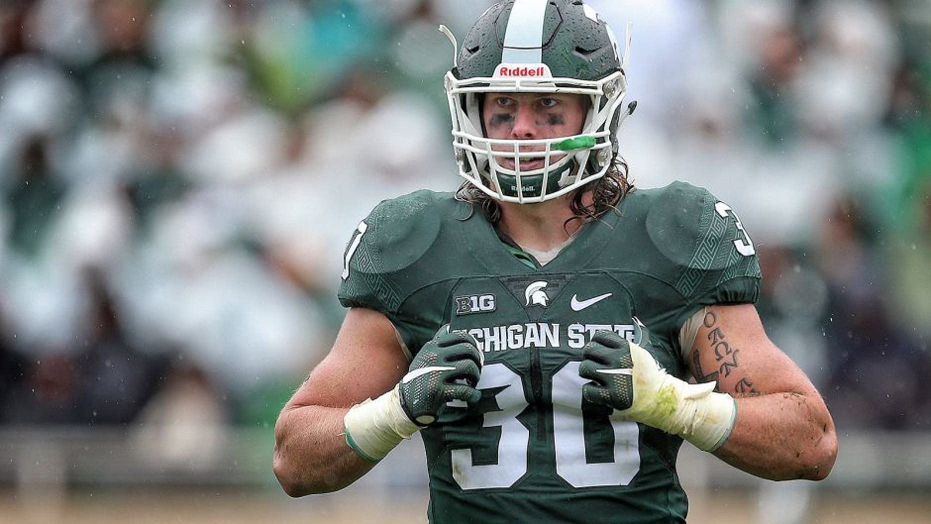 Oct 3, 2015; East Lansing, MI, USA; Michigan State Spartans linebacker Riley Bullough (30) looks to the sidelines during the 2nd half of a game against the Purdue Boilermakers at Spartan Stadium. MSU won 24-21. Mandatory Credit: Mike Carter-USA TODAY Sports