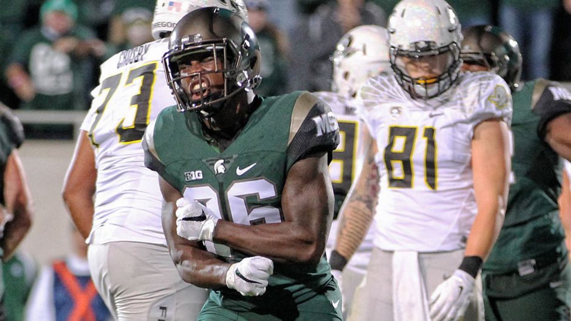 Sep 12, 2015; East Lansing, MI, USA; Michigan State Spartans safety Rj Williamson (26) celebrates goal line stand against the Oregon Ducks during the 1st half of a game at Spartan Stadium. Mandatory Credit: Mike Carter-USA TODAY Sports