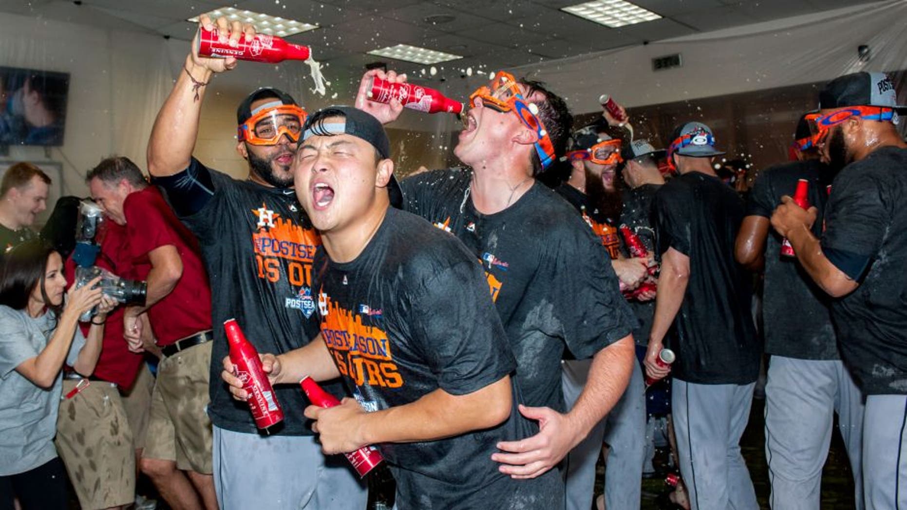PHOENIX, AZ - OCTOBER 4: Hank Conger #16 of the Houston Astros celebrates with his team after clinching an American League wild card spot after a MLB game against the Arizona Diamondbacks on October 4, 2015 at Chase Field in Phoenix, Arizona. (Photo by Darin Wallentine/Getty Images)