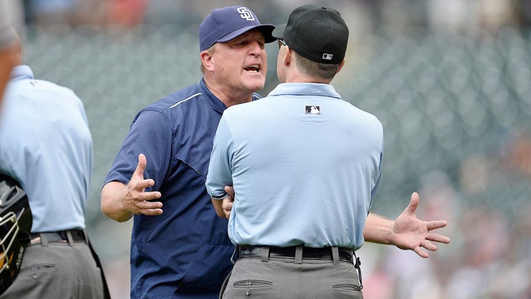 Aug 16, 2015; Denver, CO, USA; San Diego Padres interim manager Pat Murphy (24) argues with third base umpire Dan Iassogna (58) following a replay call in the seventh inning against the Colorado Rockies at Coors Field. The Rockies defeated the Padres 5-0. Mandatory Credit: Ron Chenoy-USA TODAY Sports
