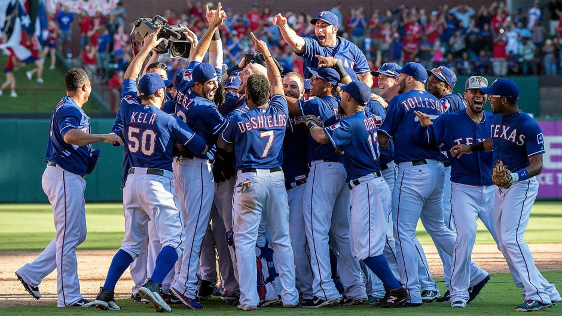 Oct 4, 2015; Arlington, TX, USA; The Texas Rangers celebrate their win over the Los Angeles Angels at Globe Life Park in Arlington. The Texas Rangers defeat the Angels 9-2 and clinch the American League West division. Mandatory Credit: Jerome Miron-USA TODAY Sports