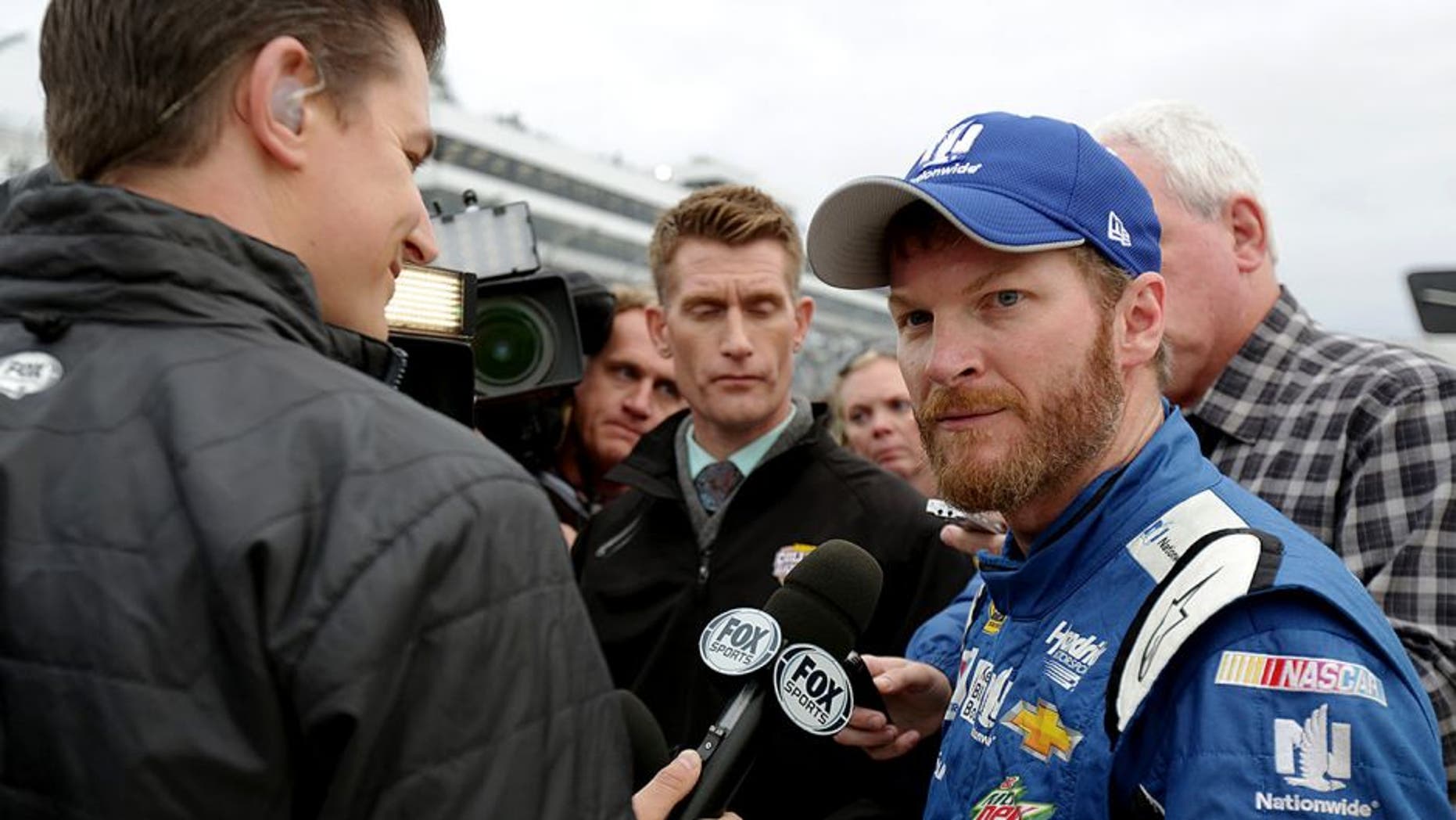 DOVER, DE - OCTOBER 04: Dale Earnrhardt Jr., driver of the #88 Nationwide Plenti Chevrolet, is interviewed on pit road after the NASCAR Sprint Cup Series AAA 400 at Dover International Speedway on October 4, 2015 in Dover, Delaware. Earnhardt Jr. advanced to the next round of the Chase For The Championship. (Photo by Jerry Markland/Getty Images)