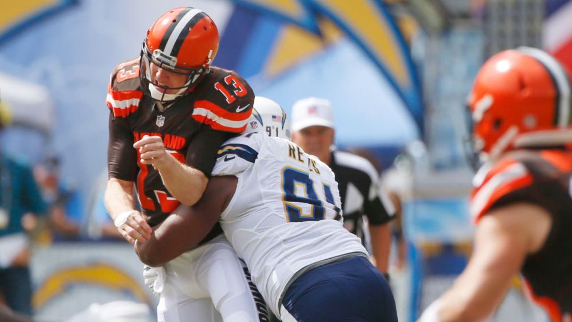 Cleveland Browns quarterback Josh McCown is hit by San Diego Chargers defensive end Kendall Reyes as he throws a pass during the first half in an NFL football game Sunday, Oct. 4, 2015, in San Diego. (AP Photo/Lenny Ignelzi)