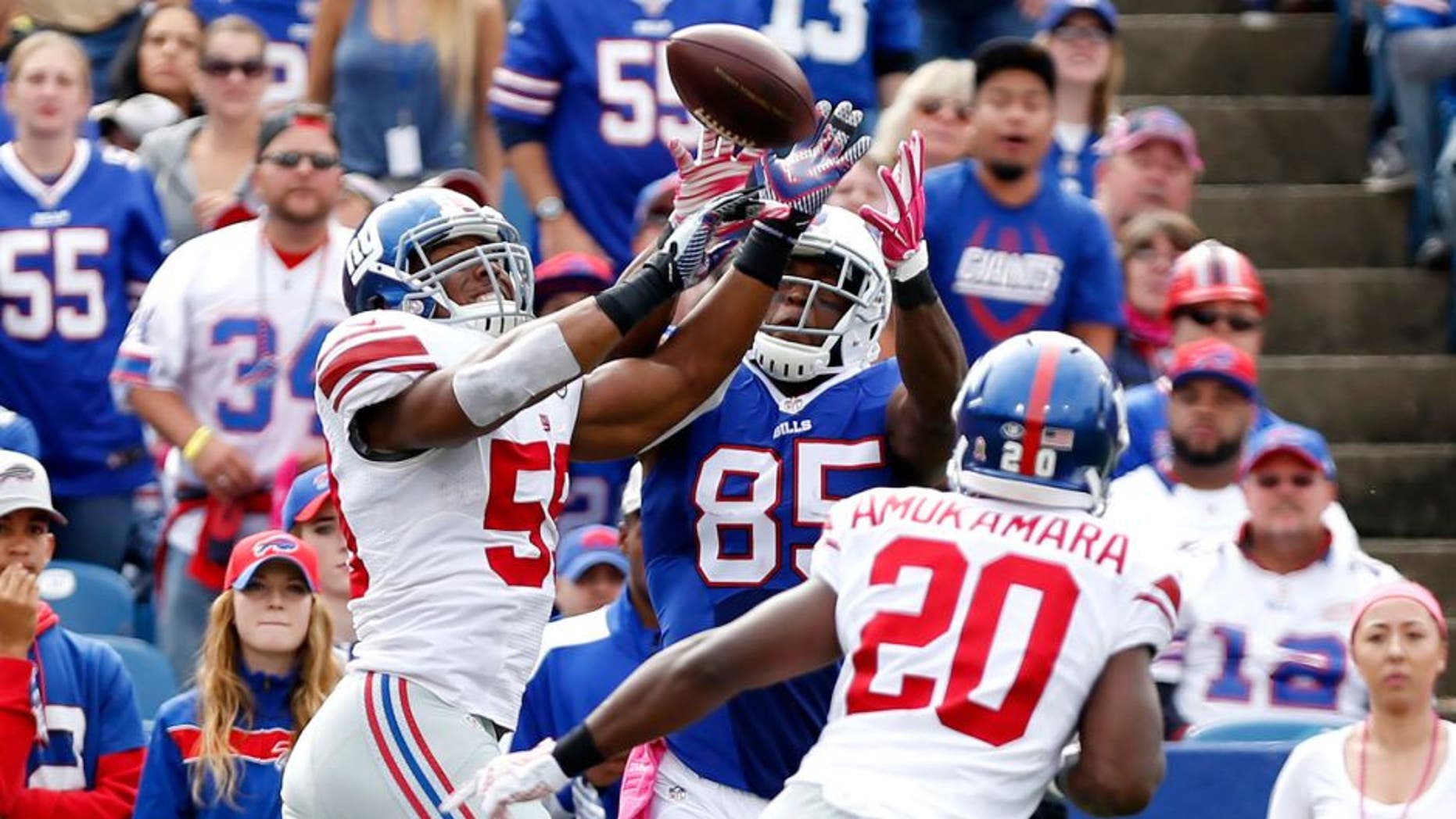 Oct 4, 2015; Orchard Park, NY, USA; New York Giants outside linebacker Devon Kennard (59) intercepts a pass intended for Buffalo Bills tight end Charles Clay (85) during the first half at Ralph Wilson Stadium. Mandatory Credit: Kevin Hoffman-USA TODAY Sports