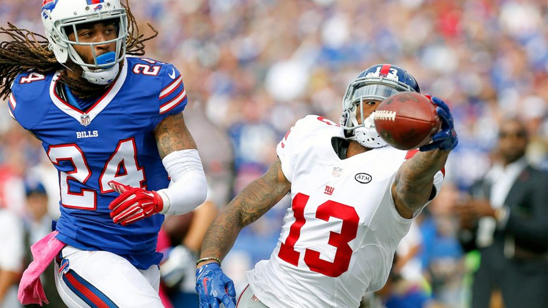 Oct 4, 2015; Orchard Park, NY, USA; New York Giants wide receiver Odell Beckham (13) reaches out but does not make the catch as Buffalo Bills cornerback Stephon Gilmore (24) defends during the first quarter at Ralph Wilson Stadium. Mandatory Credit: Kevin Hoffman-USA TODAY Sports