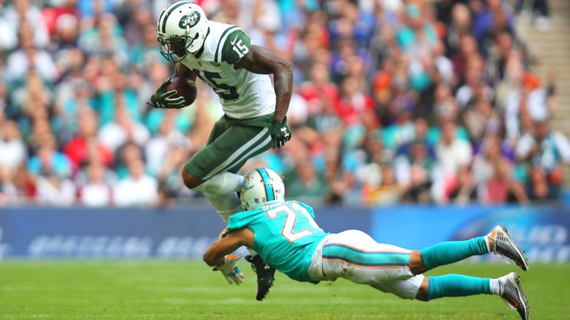 LONDON, ENGLAND - OCTOBER 04: Brandon Marshall #15 of the New York Jets is tackled by Brent Grimes #21 of the Miami Dolphins during the game at Wembley Stadium on October 4, 2015 in London, England. (Photo by Bryn Lennon/Getty Images)