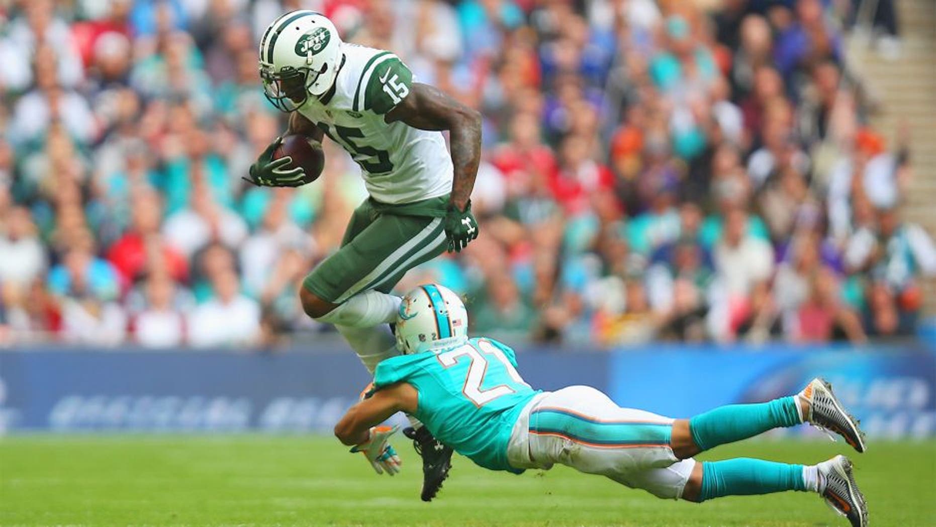 LONDON, ENGLAND - OCTOBER 04: Brandon Marshall #15 of the New York Jets is tackled by Brent Grimes #21 of the Miami Dolphins during the game at Wembley Stadium on October 4, 2015 in London, England. (Photo by Bryn Lennon/Getty Images)