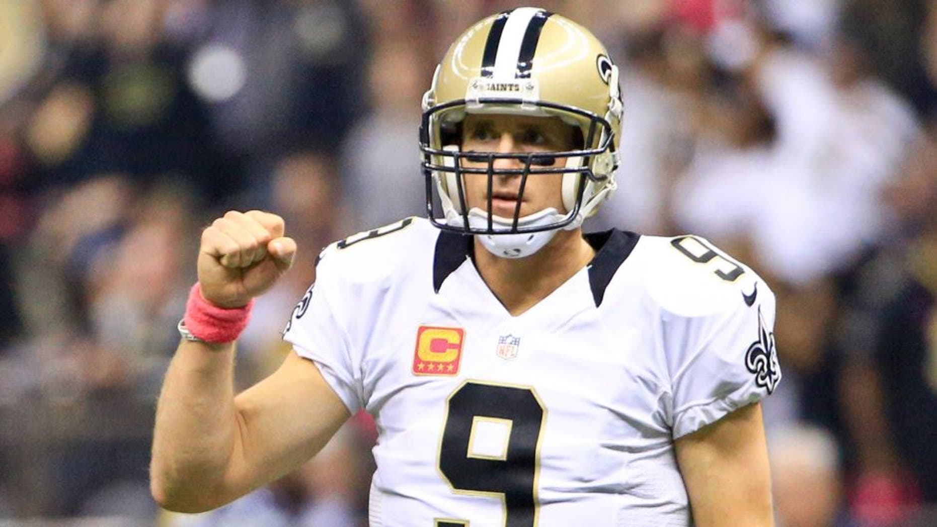 Oct 4, 2015; New Orleans, LA, USA; New Orleans Saints quarterback Drew Brees (9) celebrates after a touchdown pass against the Dallas Cowboys during the first quarter at the Mercedes-Benz Superdome. Mandatory Credit: Derick E. Hingle-USA TODAY Sports