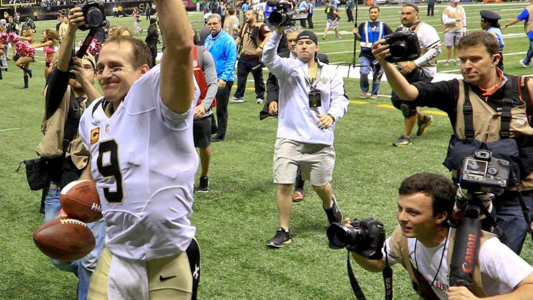 Oct 4, 2015; New Orleans, LA, USA; New Orleans Saints quarterback Drew Brees (9) walks off the field after a 80 yard game winning touchdown pass to running back C.J. Spiller (not pictured) during overtime against the Dallas Cowboys at the Mercedes-Benz Superdome. The Saints won 26-20. The touchdown pass by Brees was the 400th touchdown pass of his career. Mandatory Credit: Derick E. Hingle-USA TODAY Sports