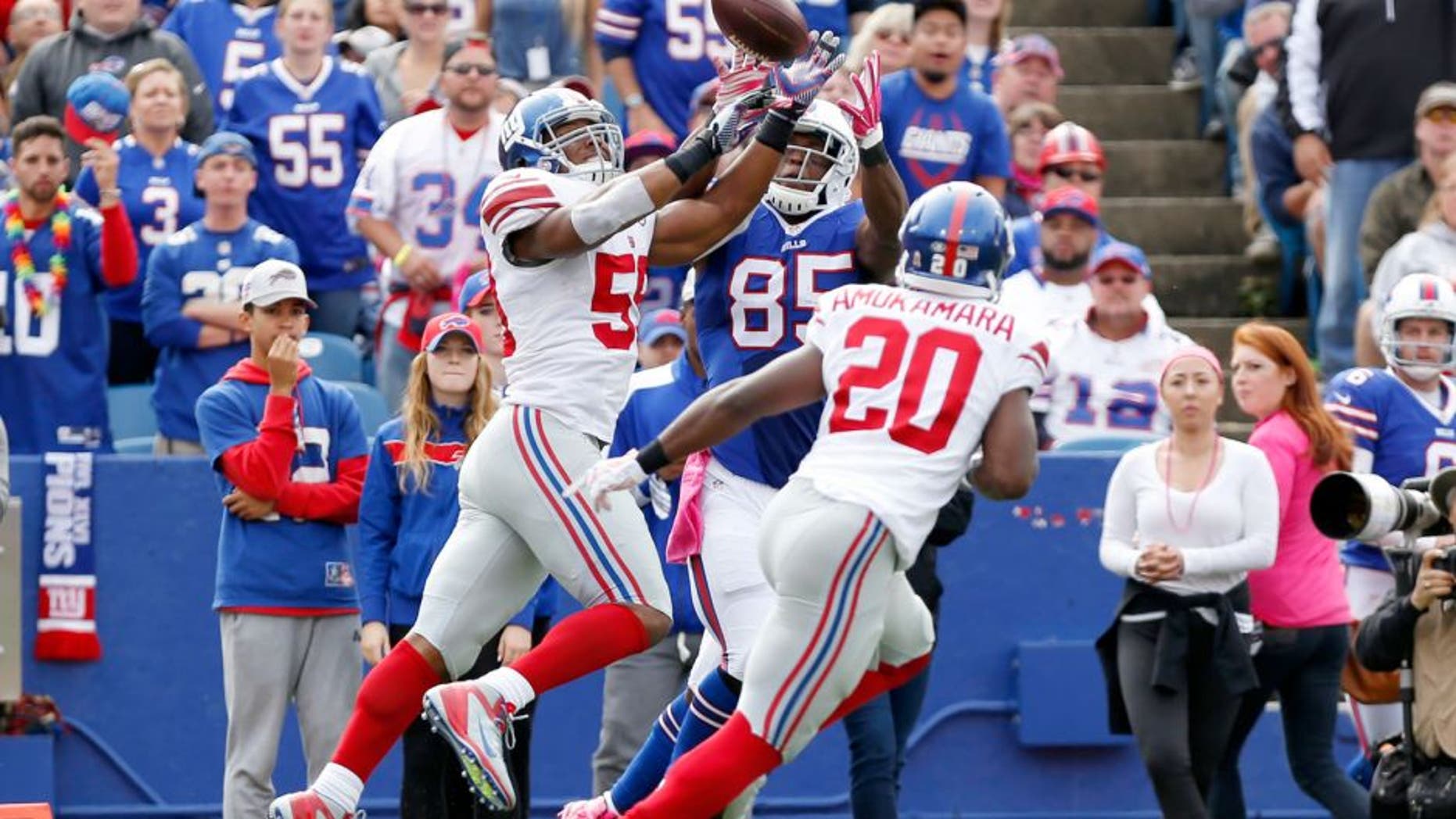 Oct 4, 2015; Orchard Park, NY, USA; New York Giants outside linebacker Devon Kennard (59) intercepts a pass intended for Buffalo Bills tight end Charles Clay (85) during the first half at Ralph Wilson Stadium. Mandatory Credit: Kevin Hoffman-USA TODAY Sports