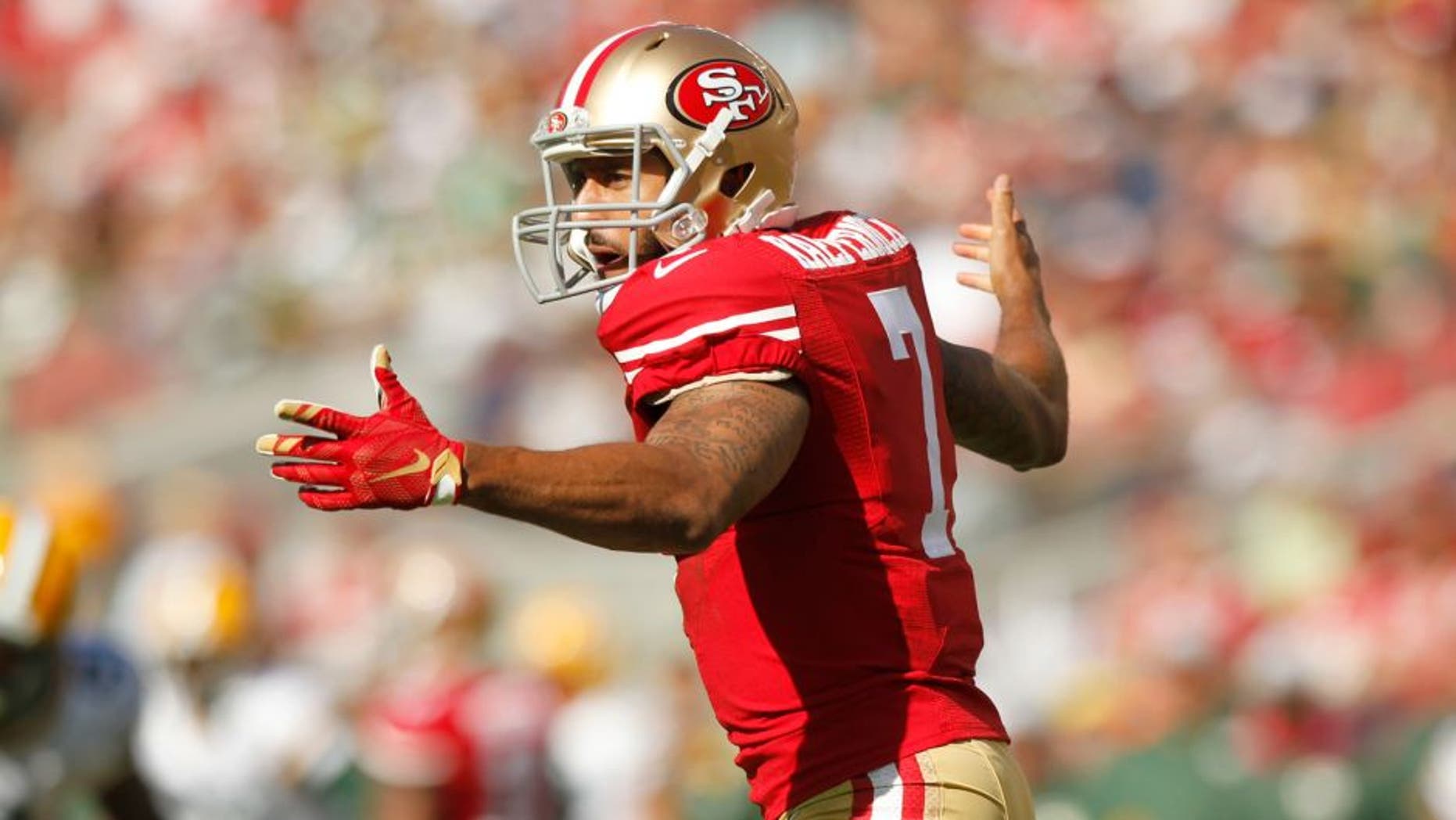 Oct 4, 2015; Santa Clara, CA, USA; San Francisco 49ers quarterback Colin Kaepernick (7) reacts after being hit on a 49ers running play against the Green Bay Packers in the third quarter at Levi's Stadium. The Packers defeated the 49ers 17-3. Mandatory Credit: Cary Edmondson-USA TODAY Sports