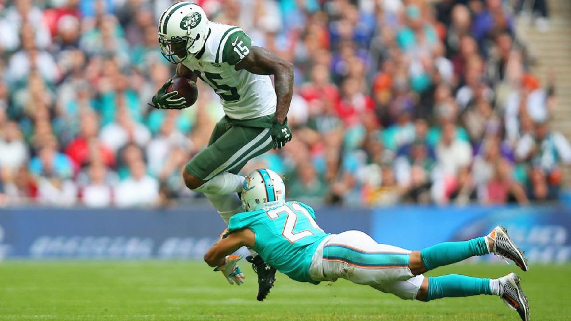 LONDON, ENGLAND - OCTOBER 04: Brandon Marshall #15 of the New York Jets is tackled by Brent Grimes #21 of the Miami Dolphins during the game at Wembley Stadium on October 4, 2015 in London, England. (Photo by Bryn Lennon/Getty Images)